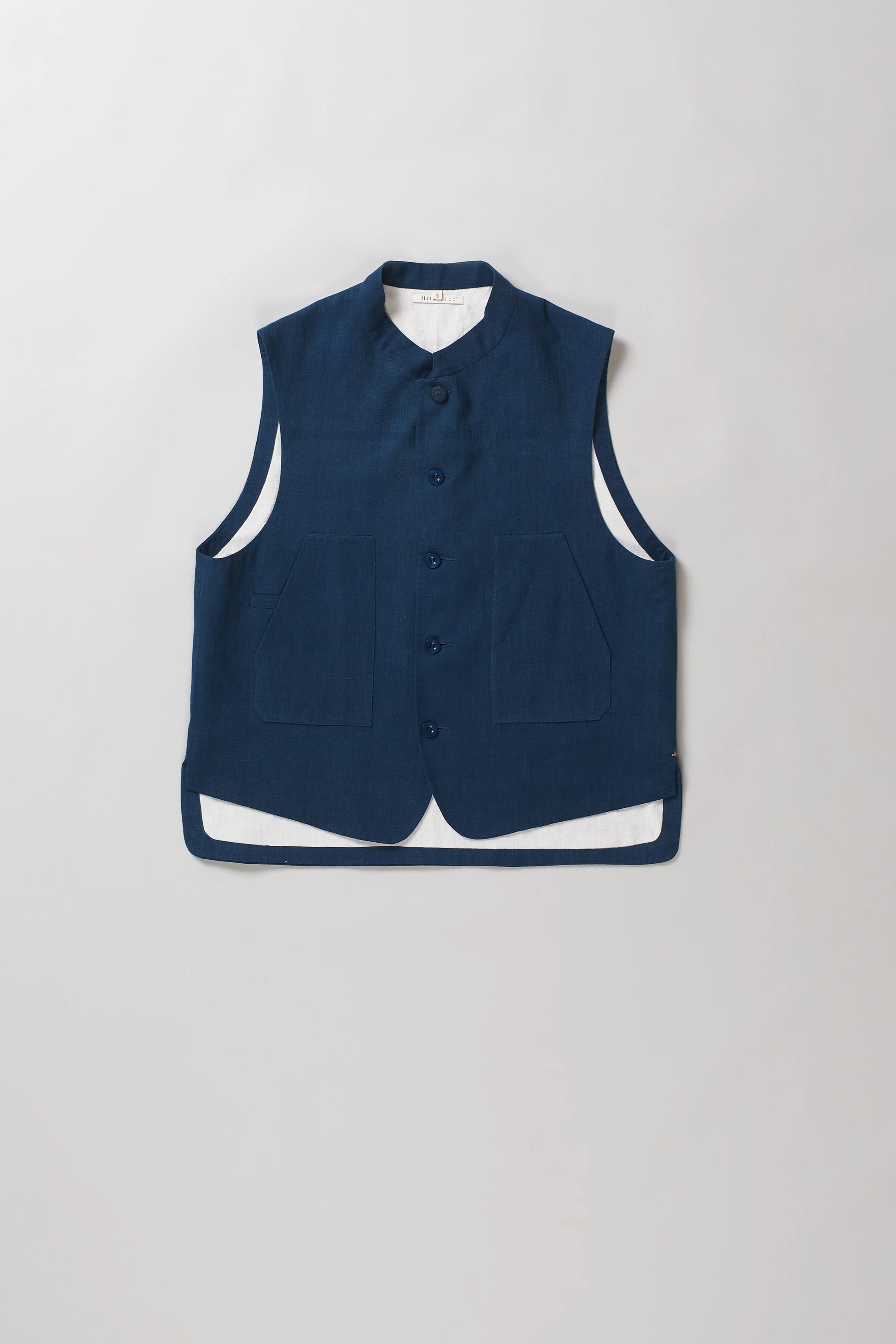 A sleeveless space blue vest with a mandarin collar and front button closure, 