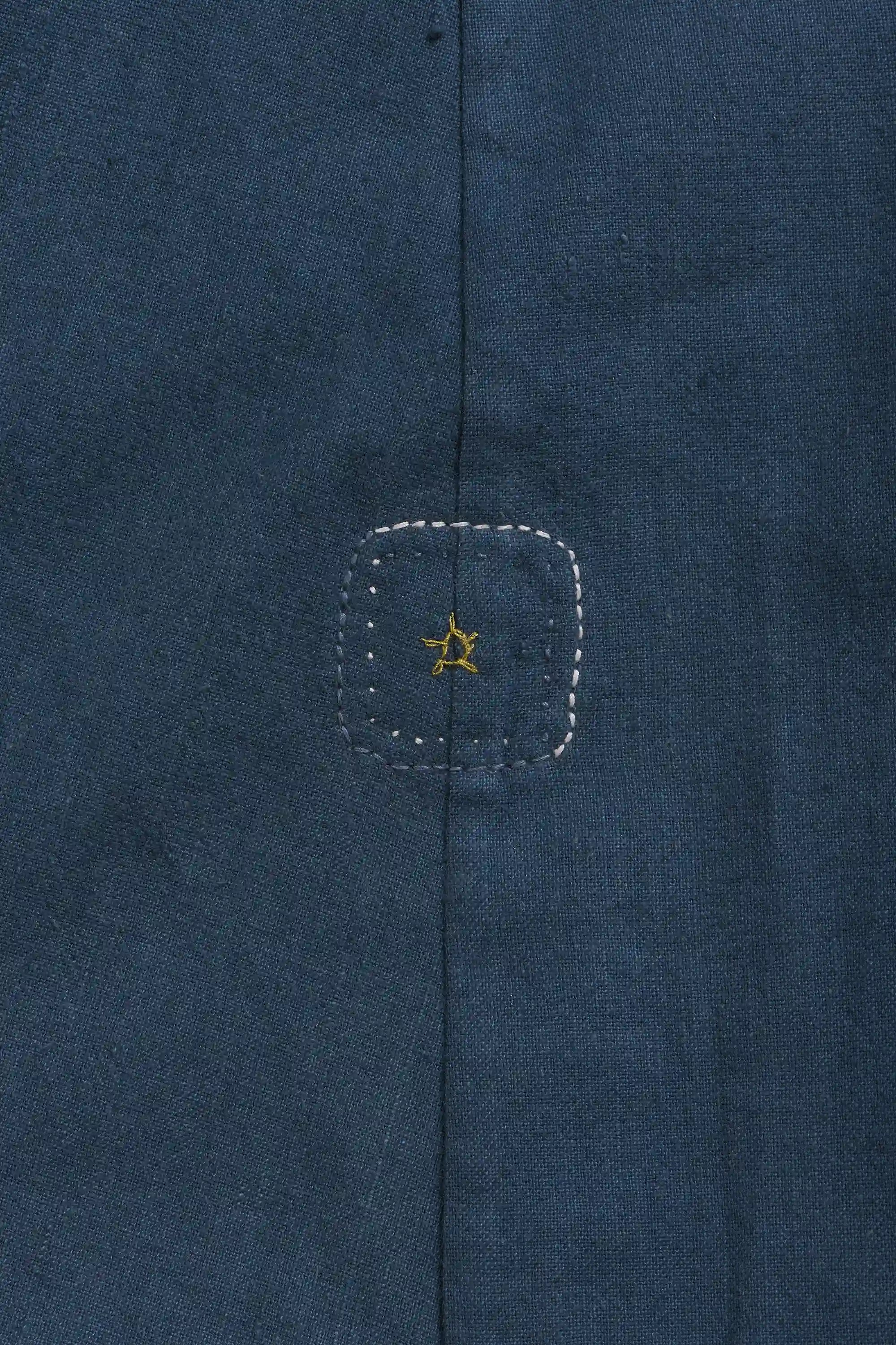 Close-up of a blue fabric with a yellow star pehchan 