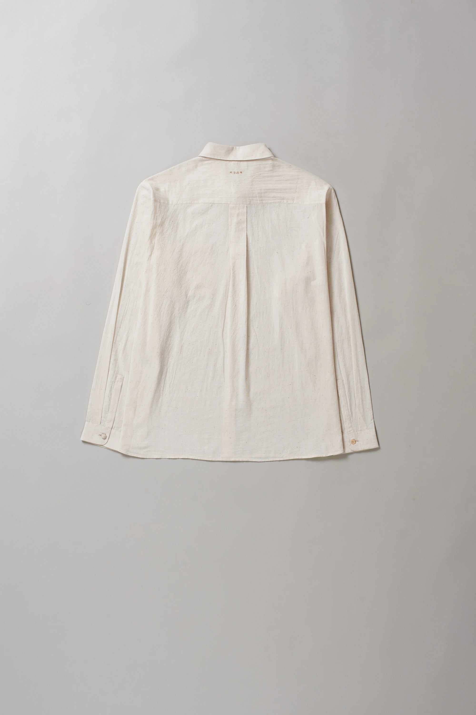 Back image of ecru shirt on a grey background