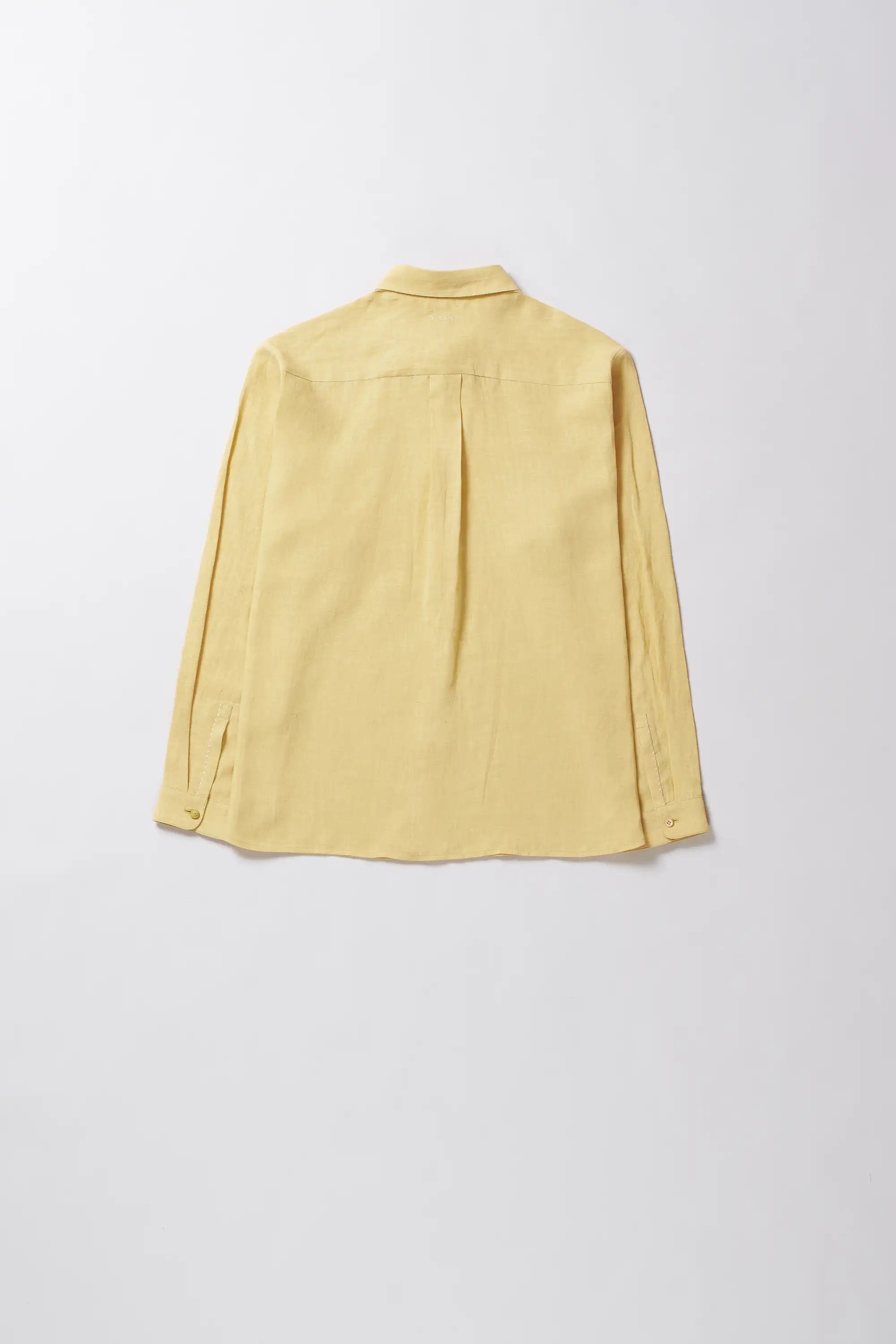 Light yellow linen shirt on a light grey background