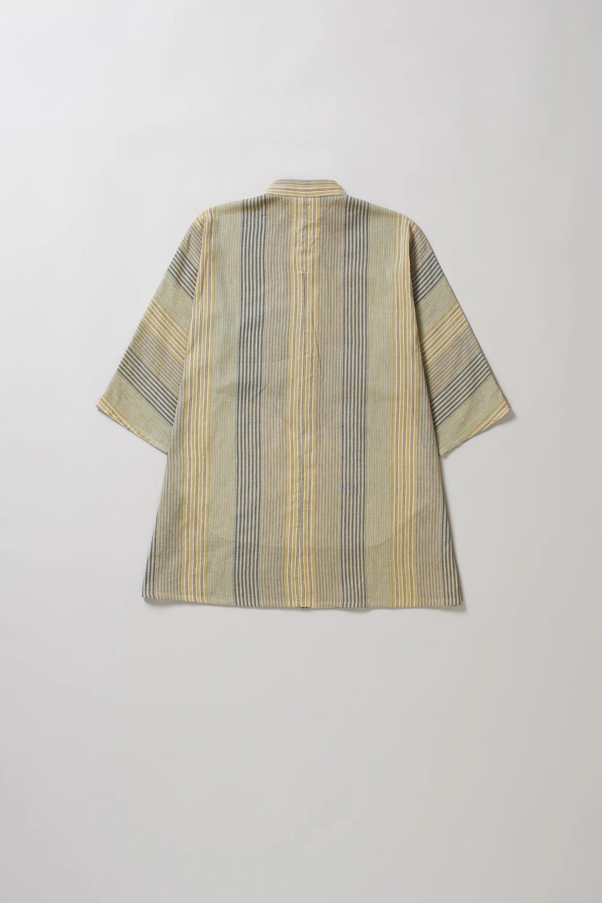 Striped shirt with a geometric pattern on a light grey background