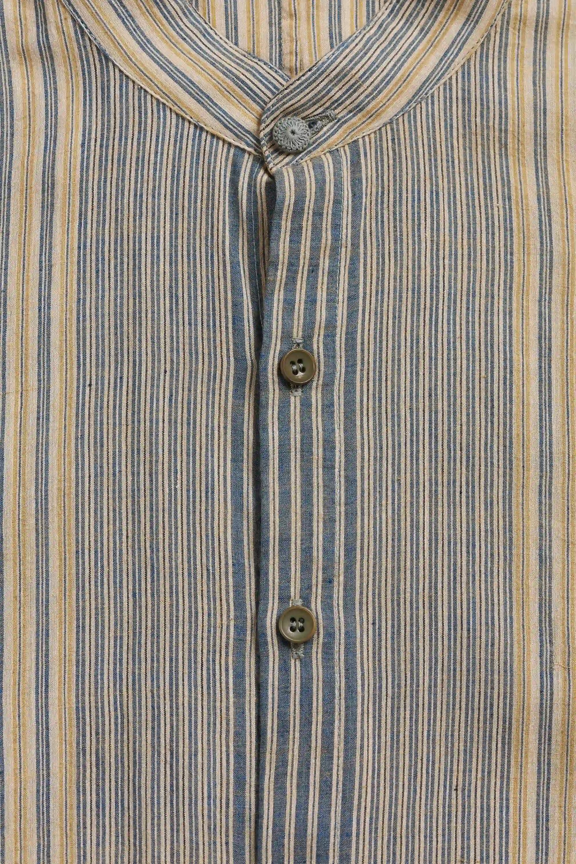 Close-up of a striped shirt and three visible buttons.