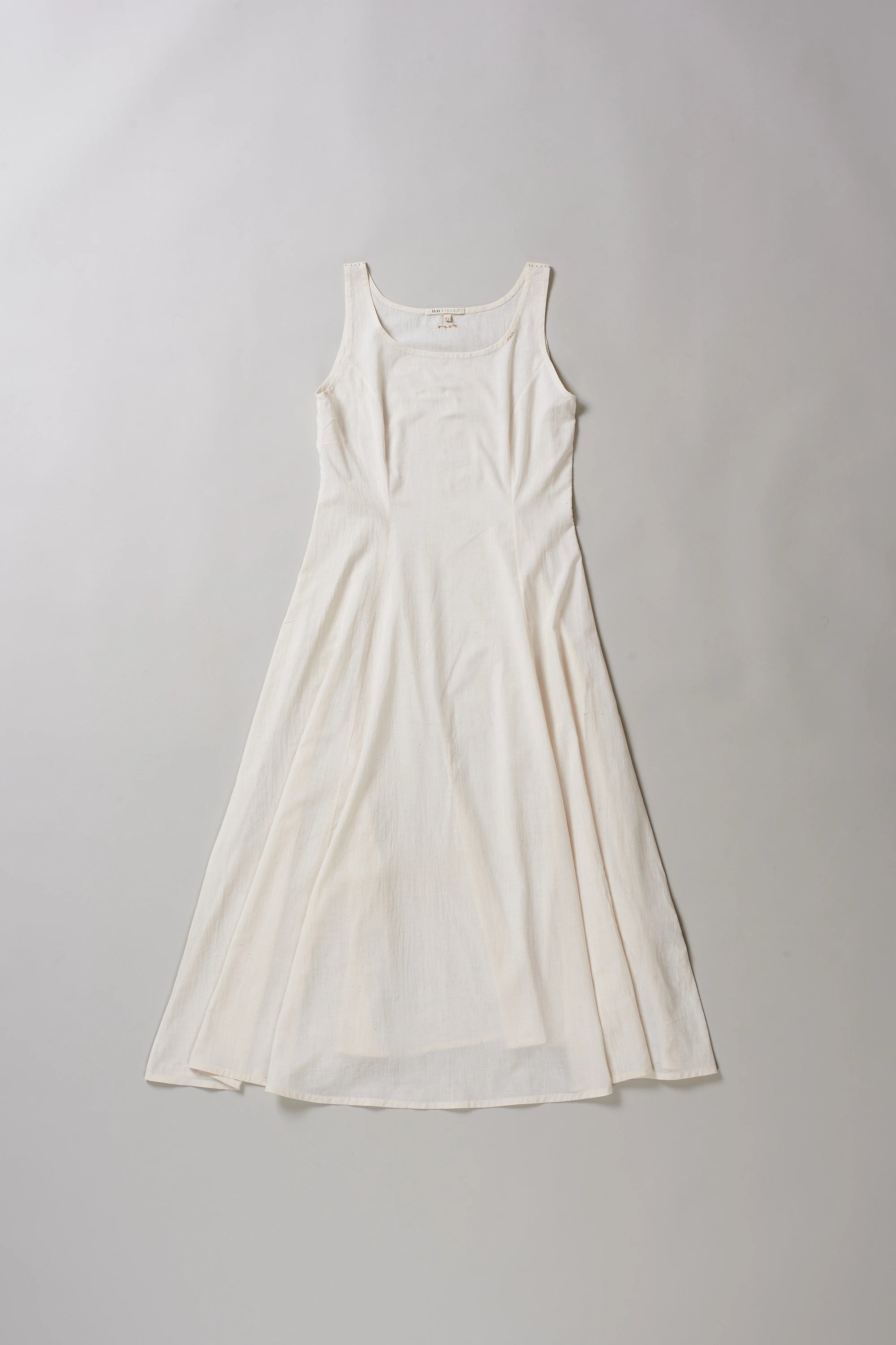 Front image of ecru dress on a grey background