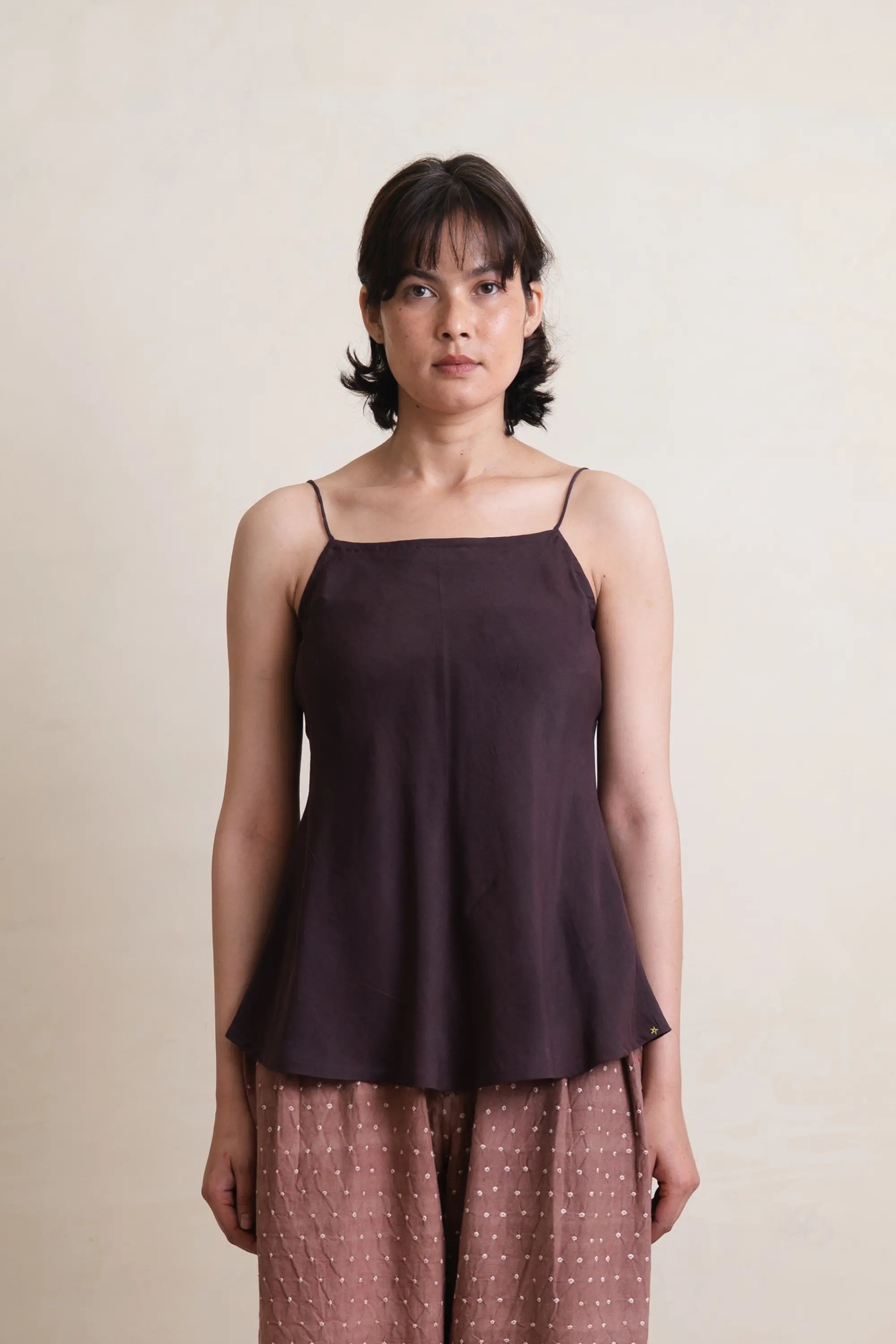 A woman wearing purple red top