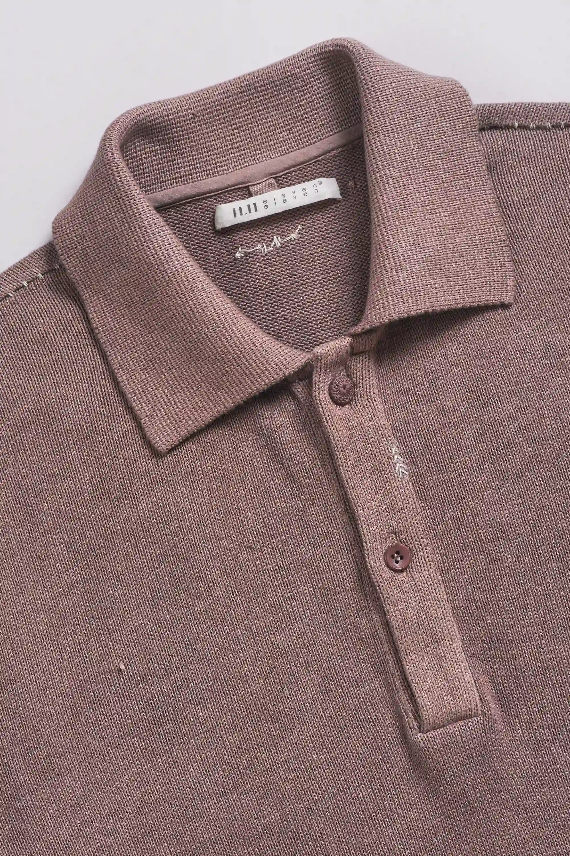 Brown polo shirt with collar and buttons on a light grey background