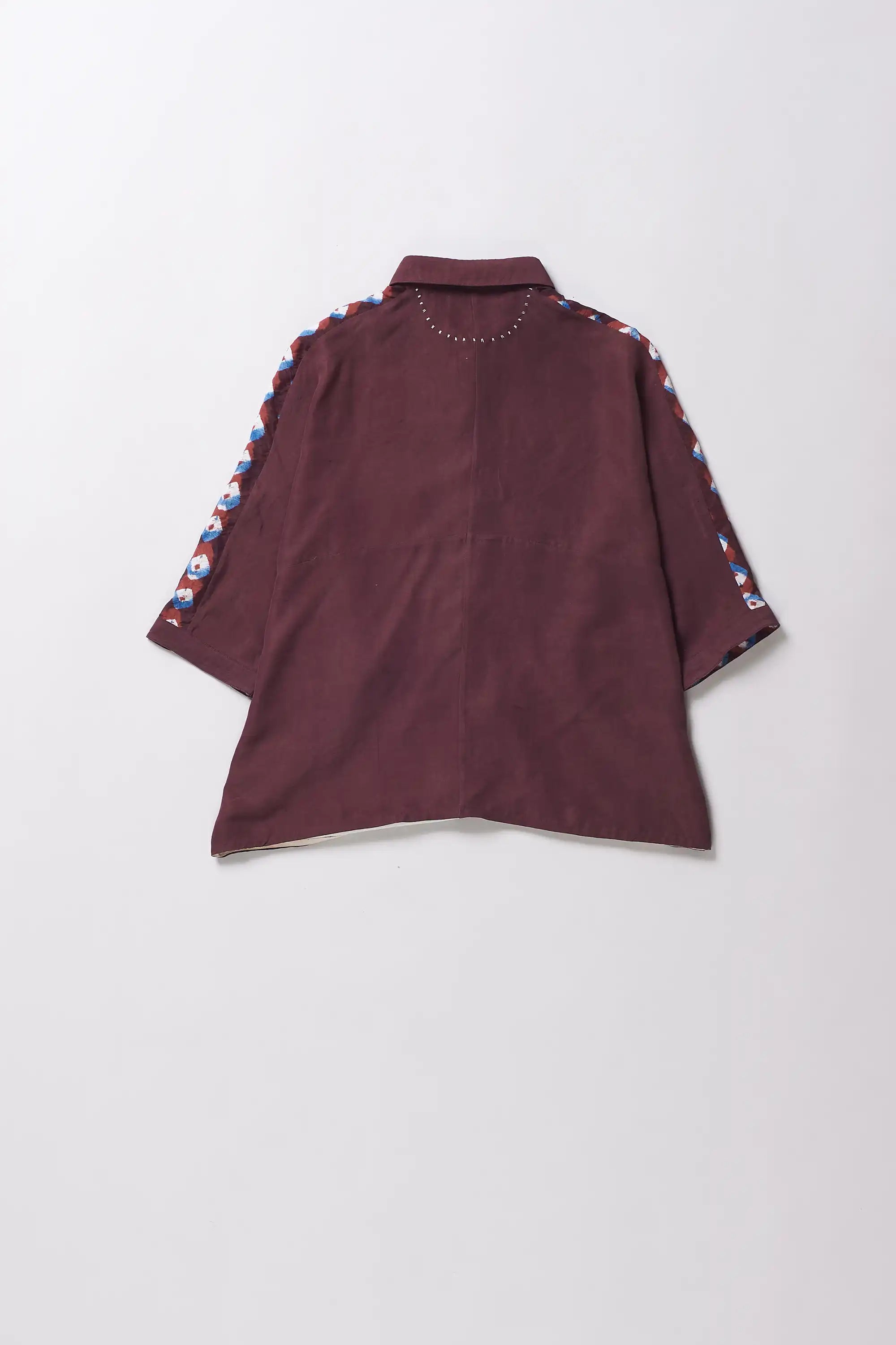 Back shot of a silk purple red bandhani shirt