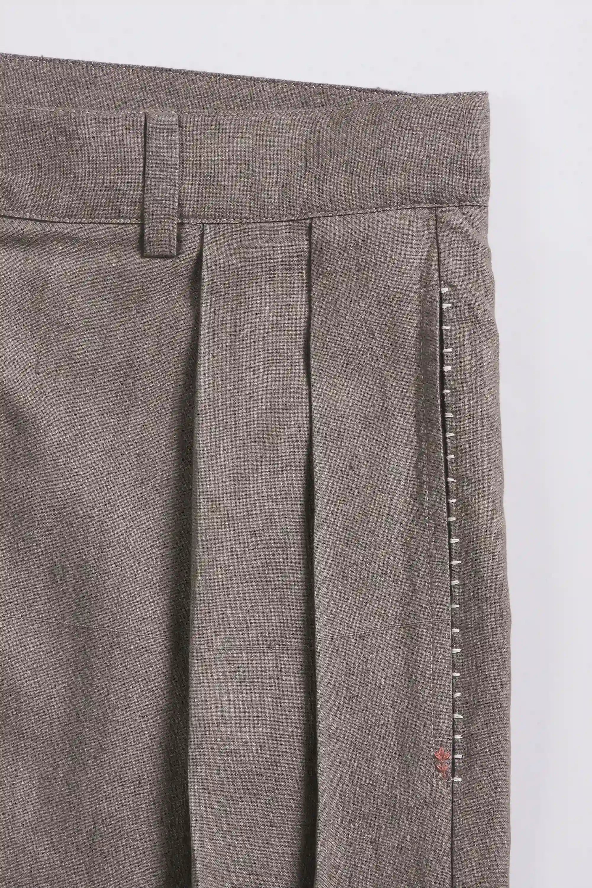 Close-up of fabric with pocket and hand detailing