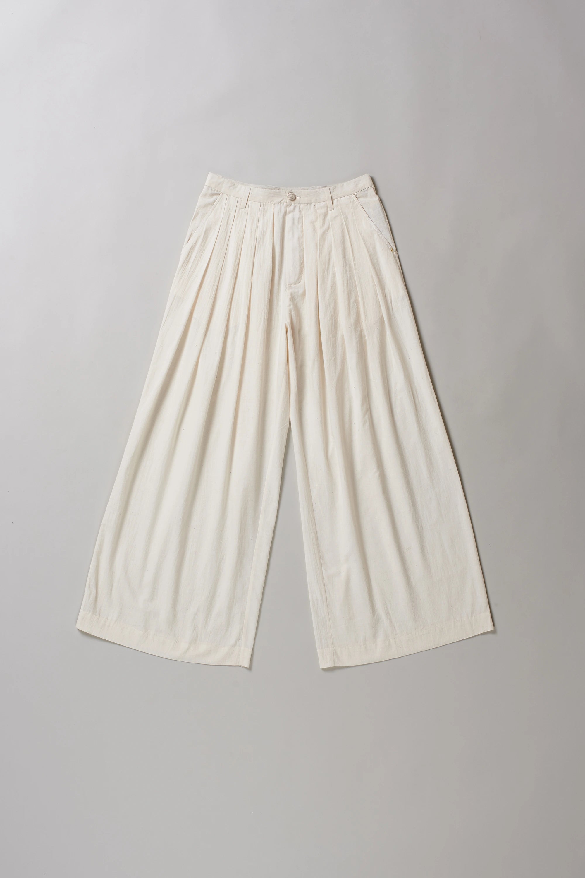 Ecru cotton pants on a grey background