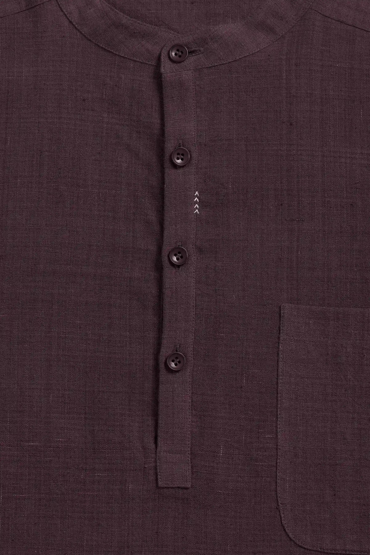 Close-up of a purple red colored shirt with a buttoned mandarin collar and a chest pocket.