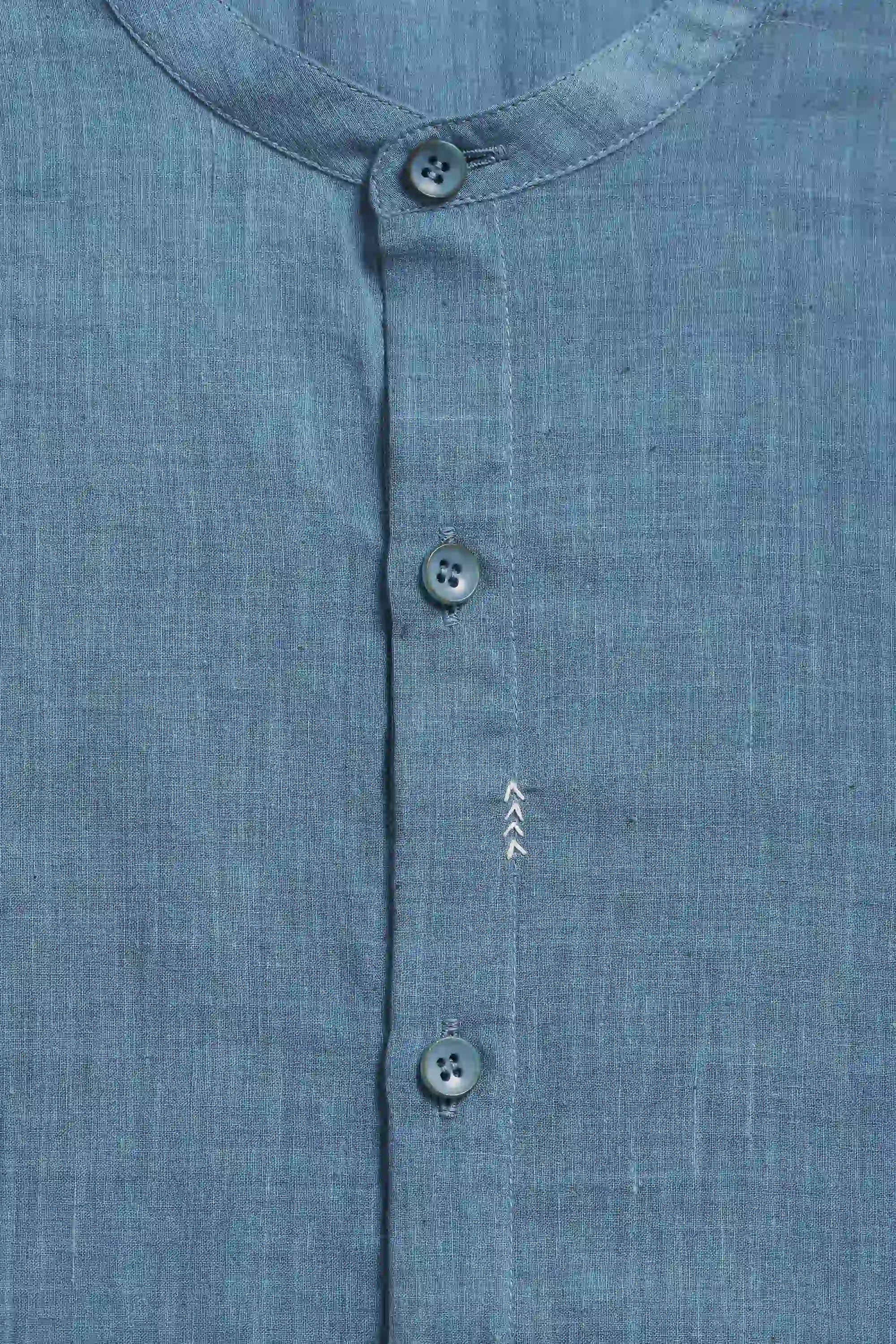 Close-up of a blue shirt with buttons and a collar