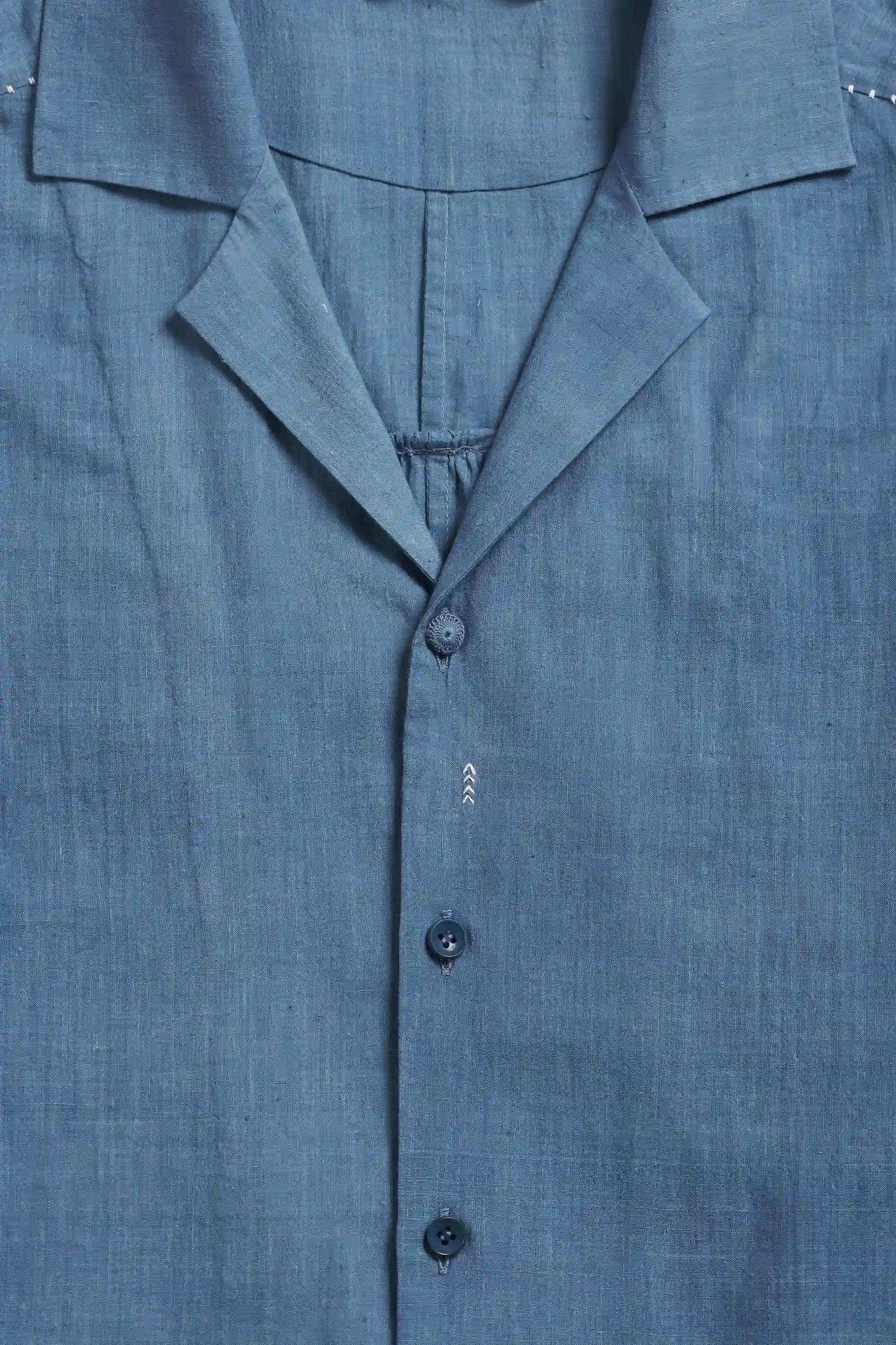 Close-up of a blue shirt with buttons and collar