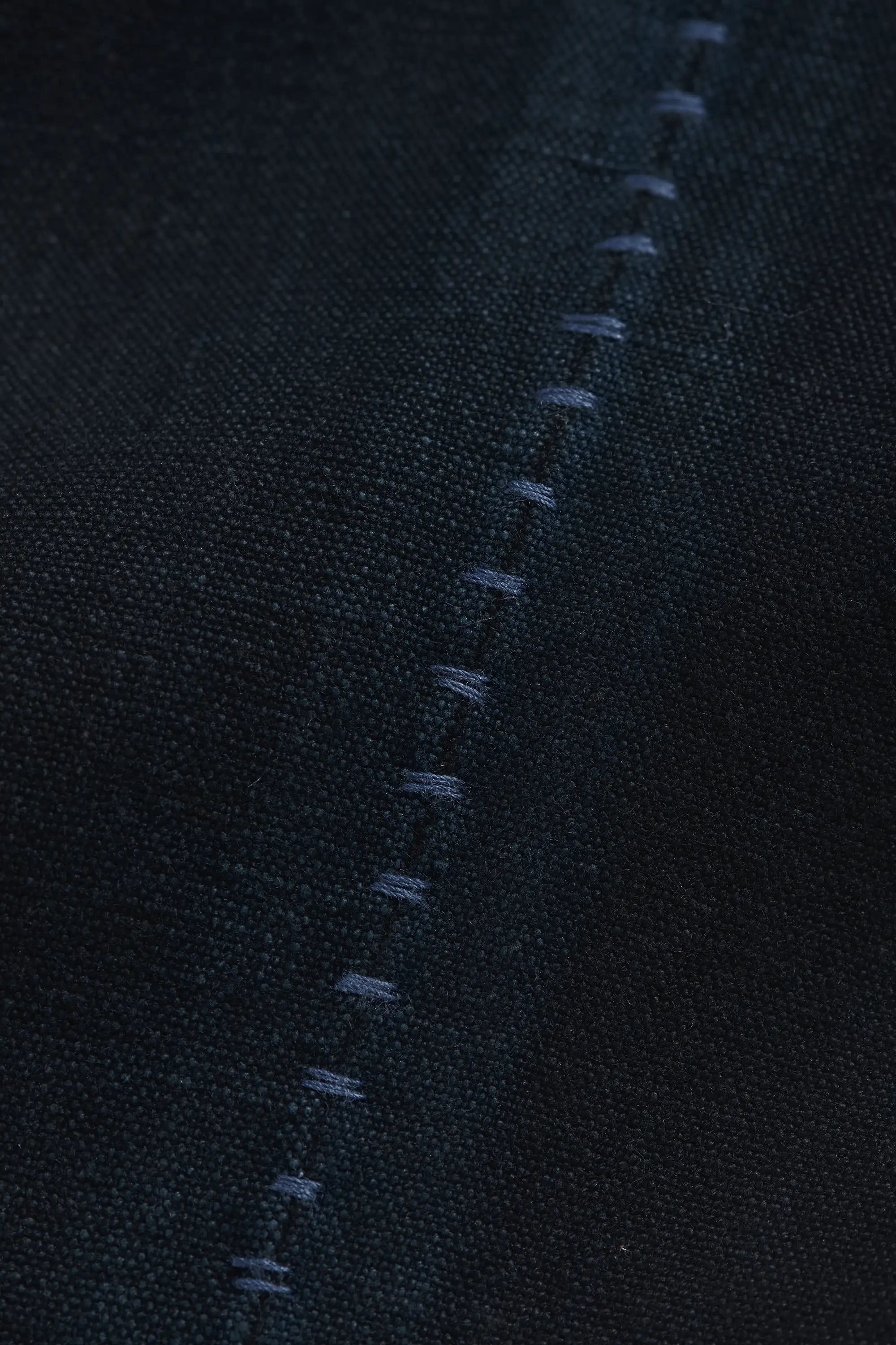 Close-up of a black fabric with hand detailing