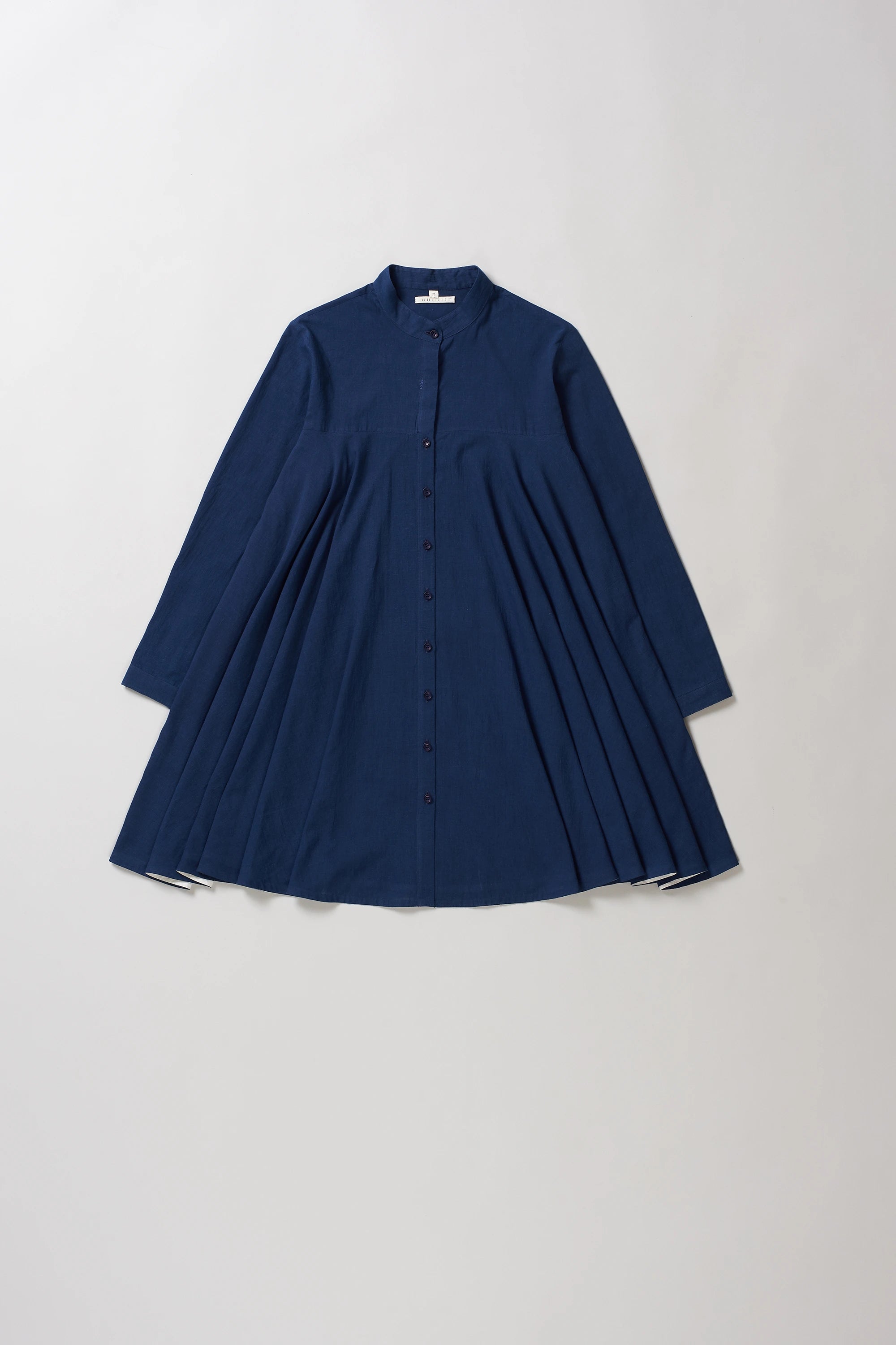 Front image of indigo dress on a light grey background