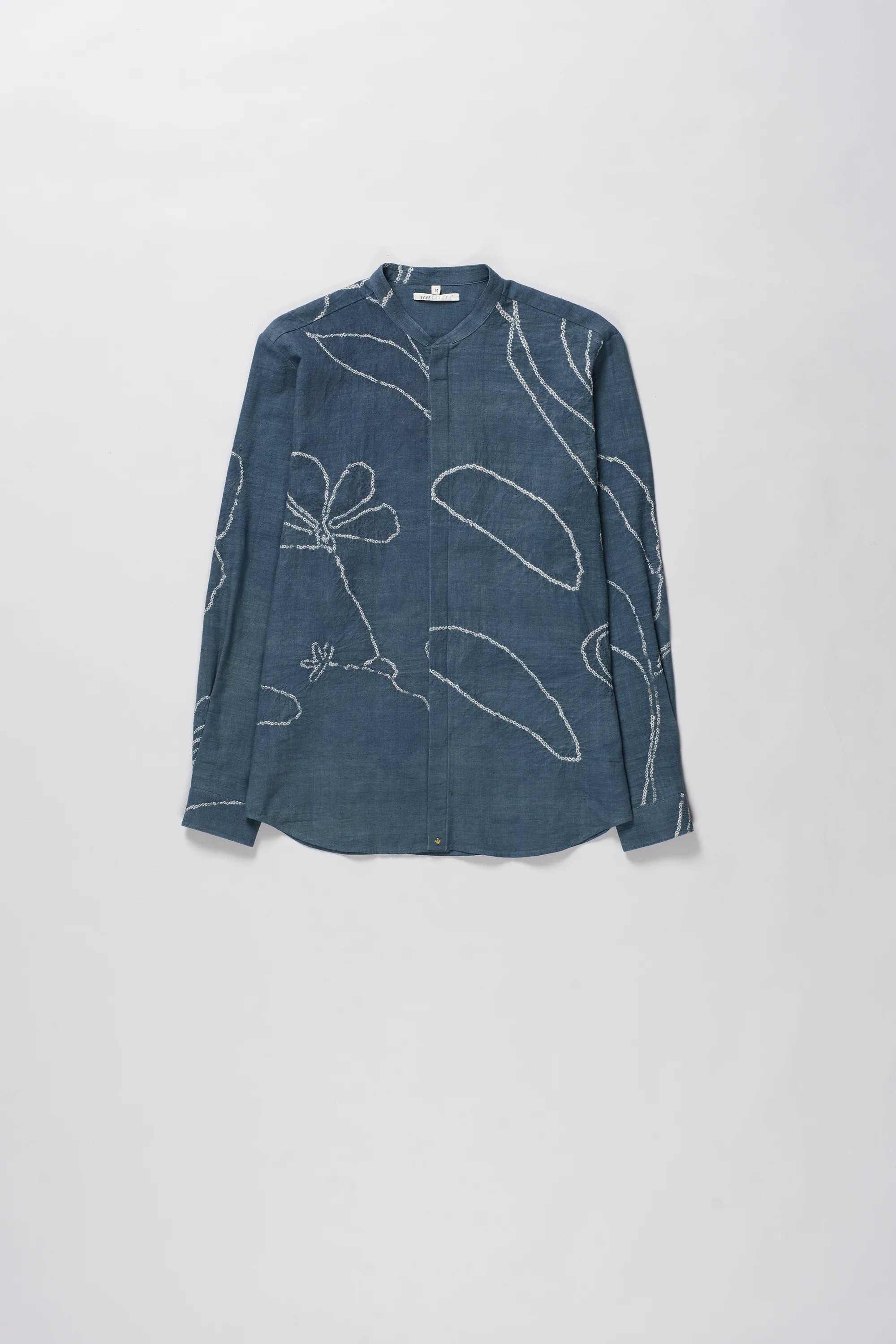 Ash indigo shirt with white floral bandhani on a light grey background