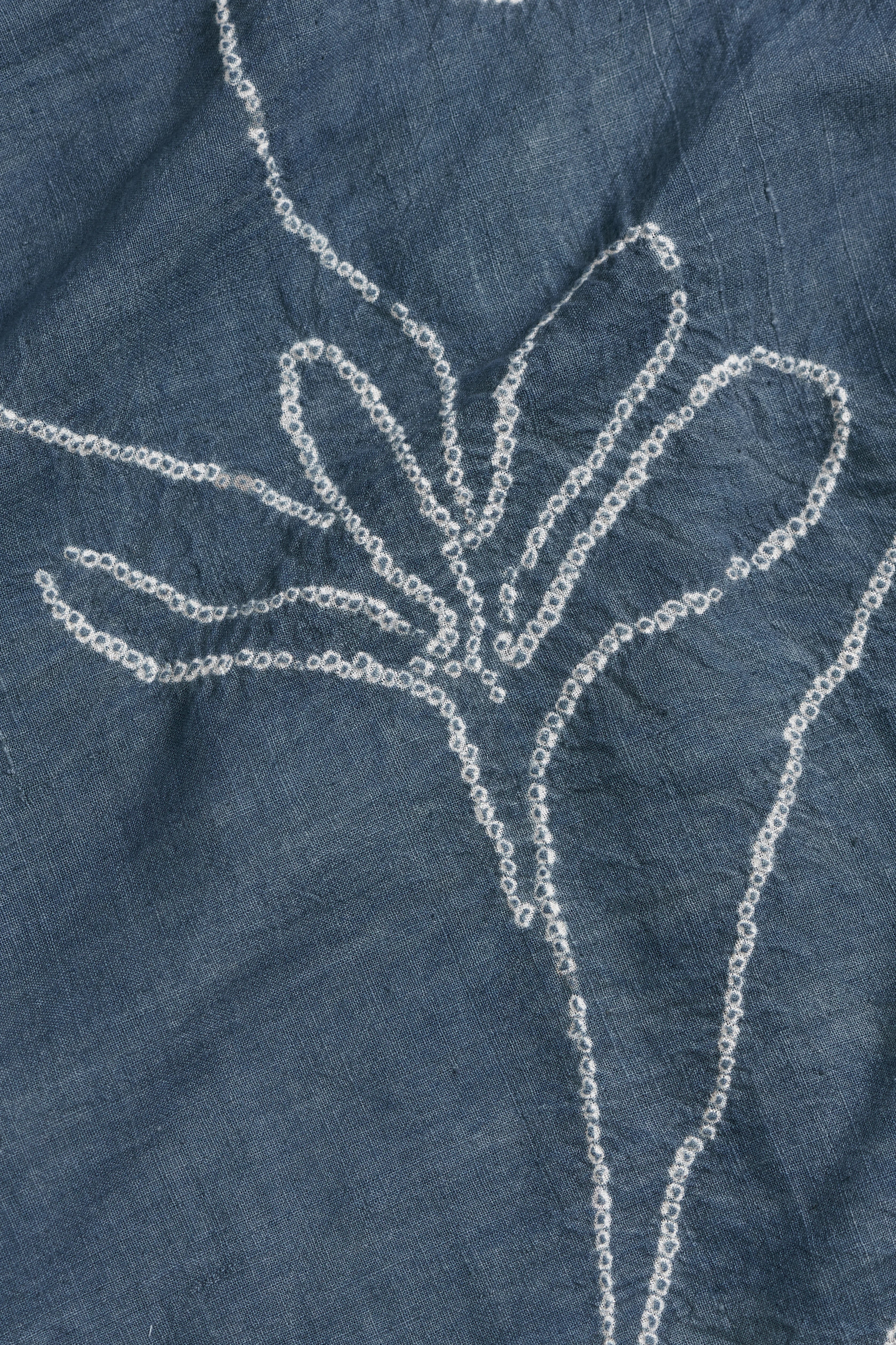 Close-up of a ash indigo fabric with bandhani floral design