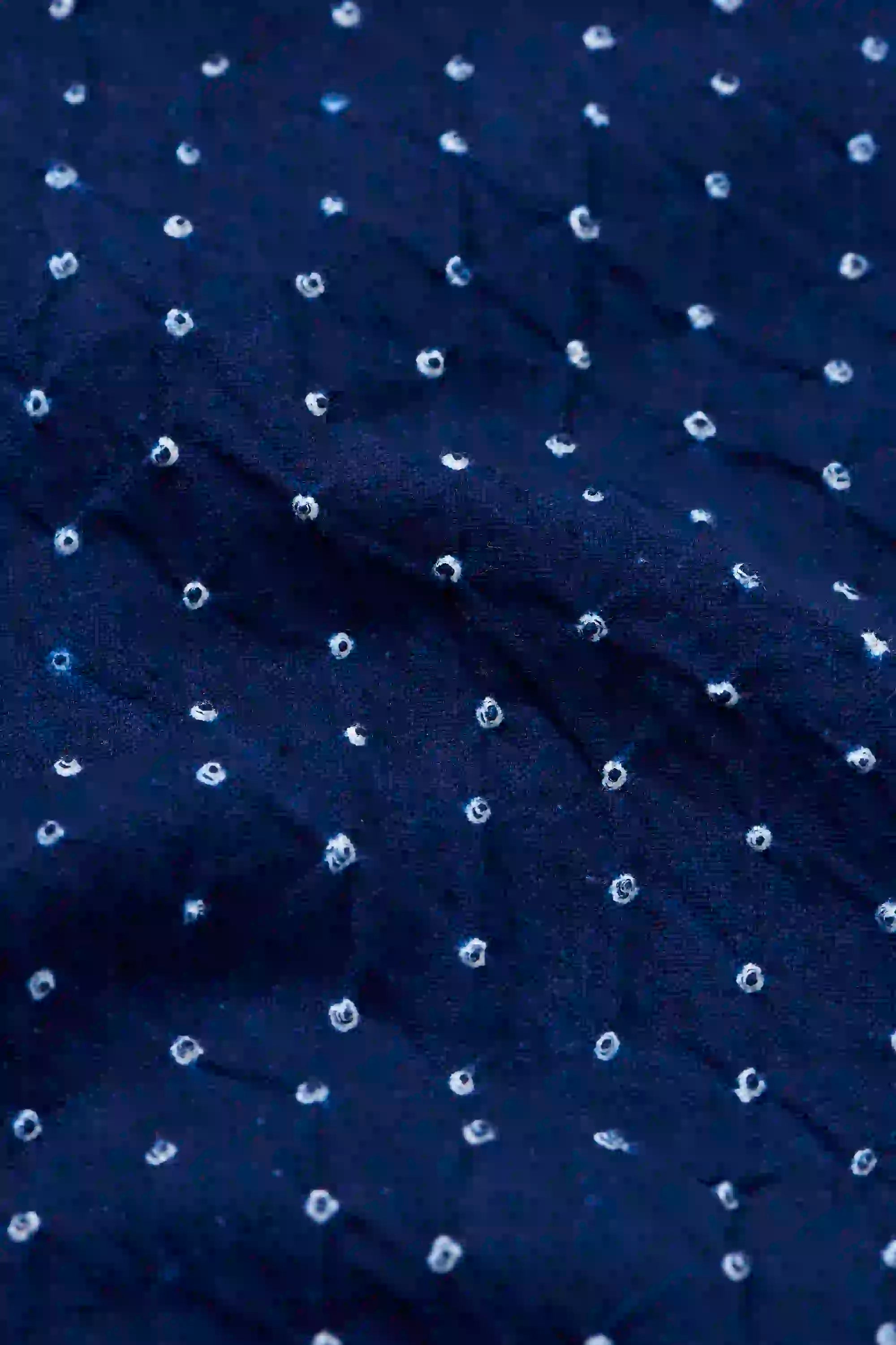 Navy blue fabric with white polka dots