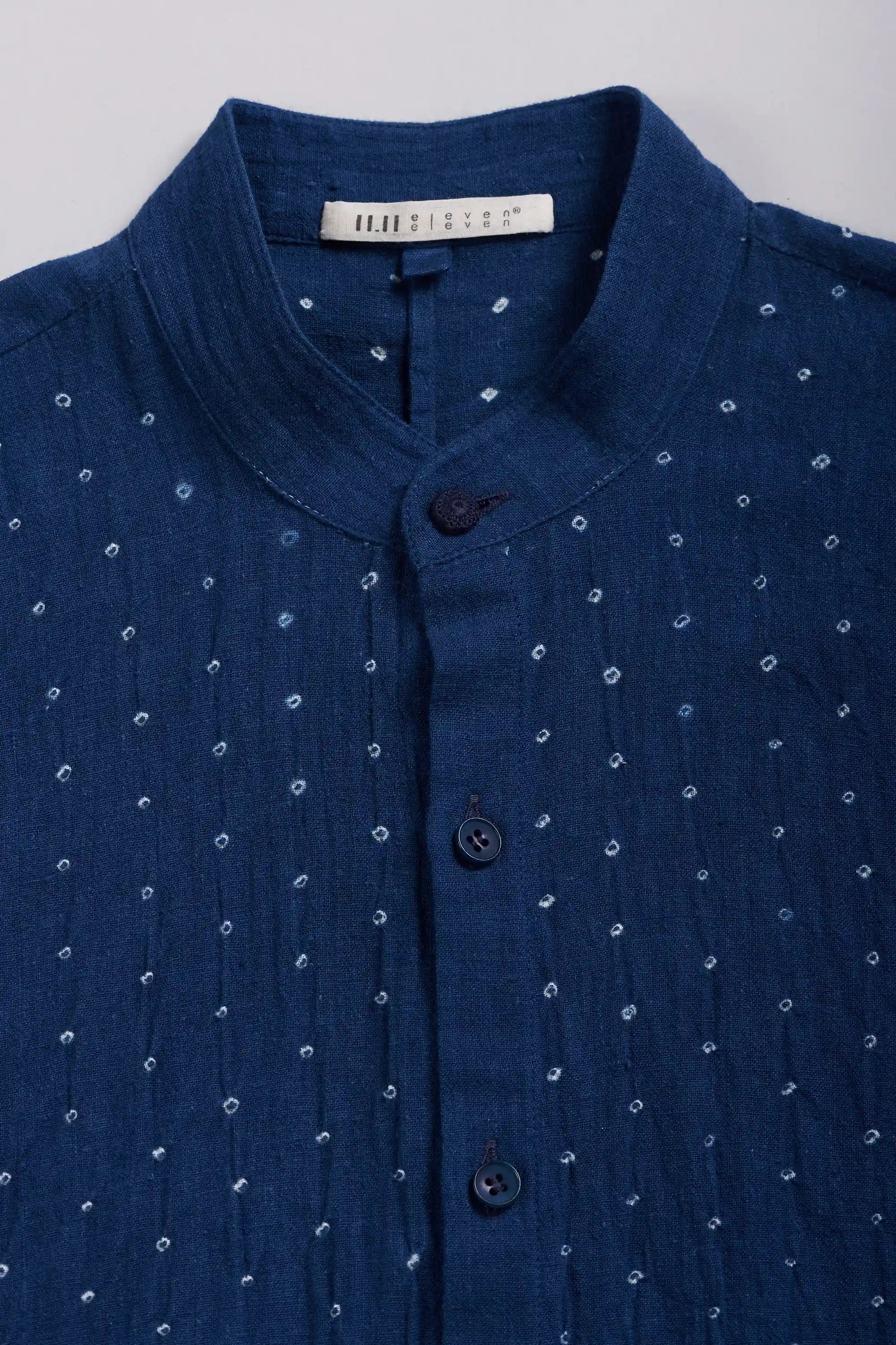 Close-up of a medium indigo shirt with button.