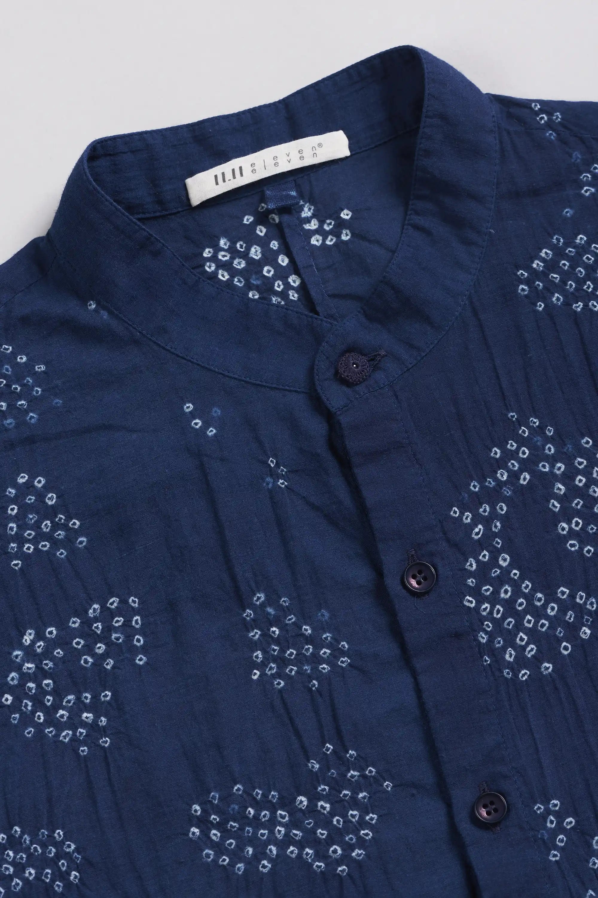 A close-up of a indigo shirt with label.