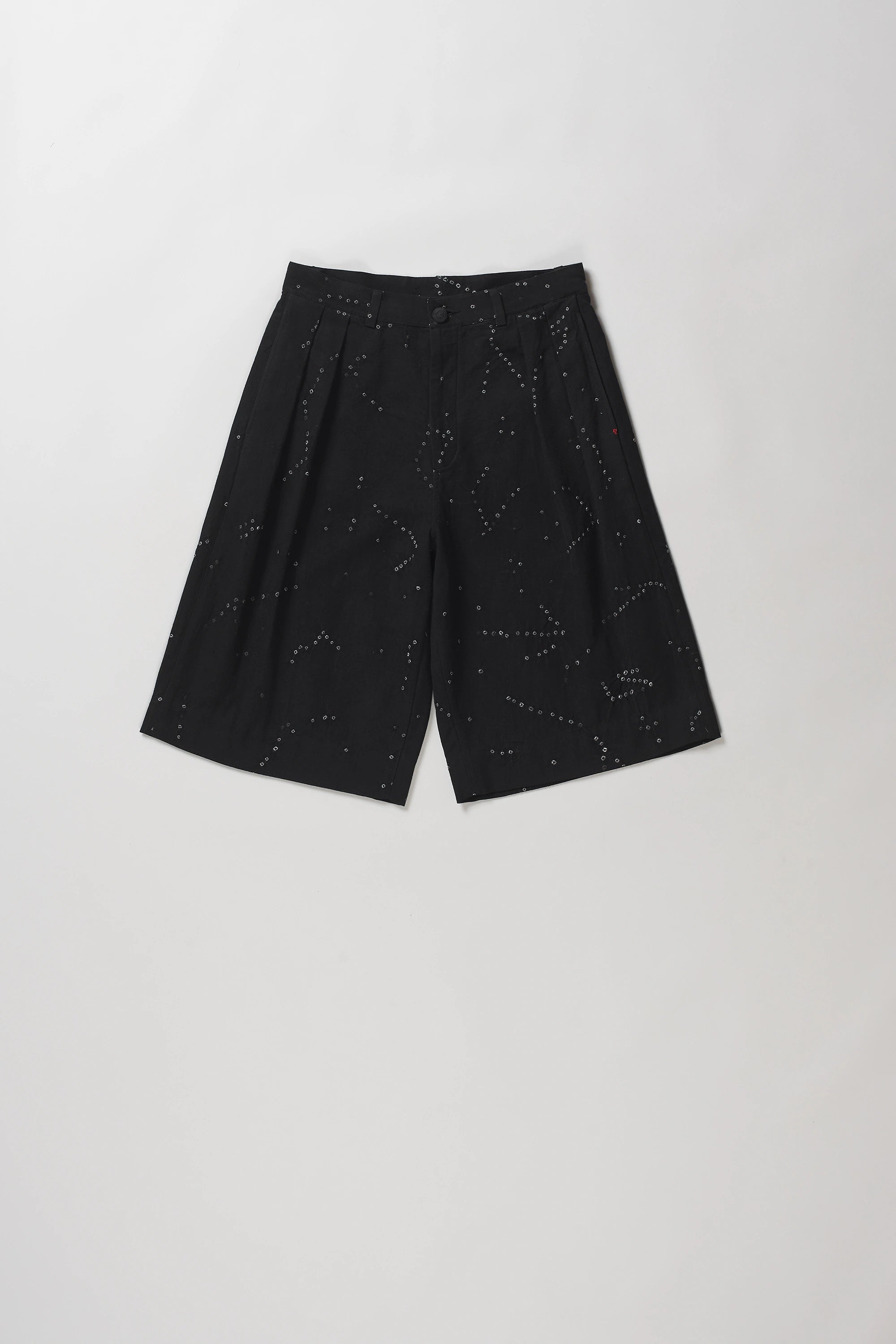 Black wide-leg shorts with a subtle white speckled constellation pattern, laid flat on a light grey background.