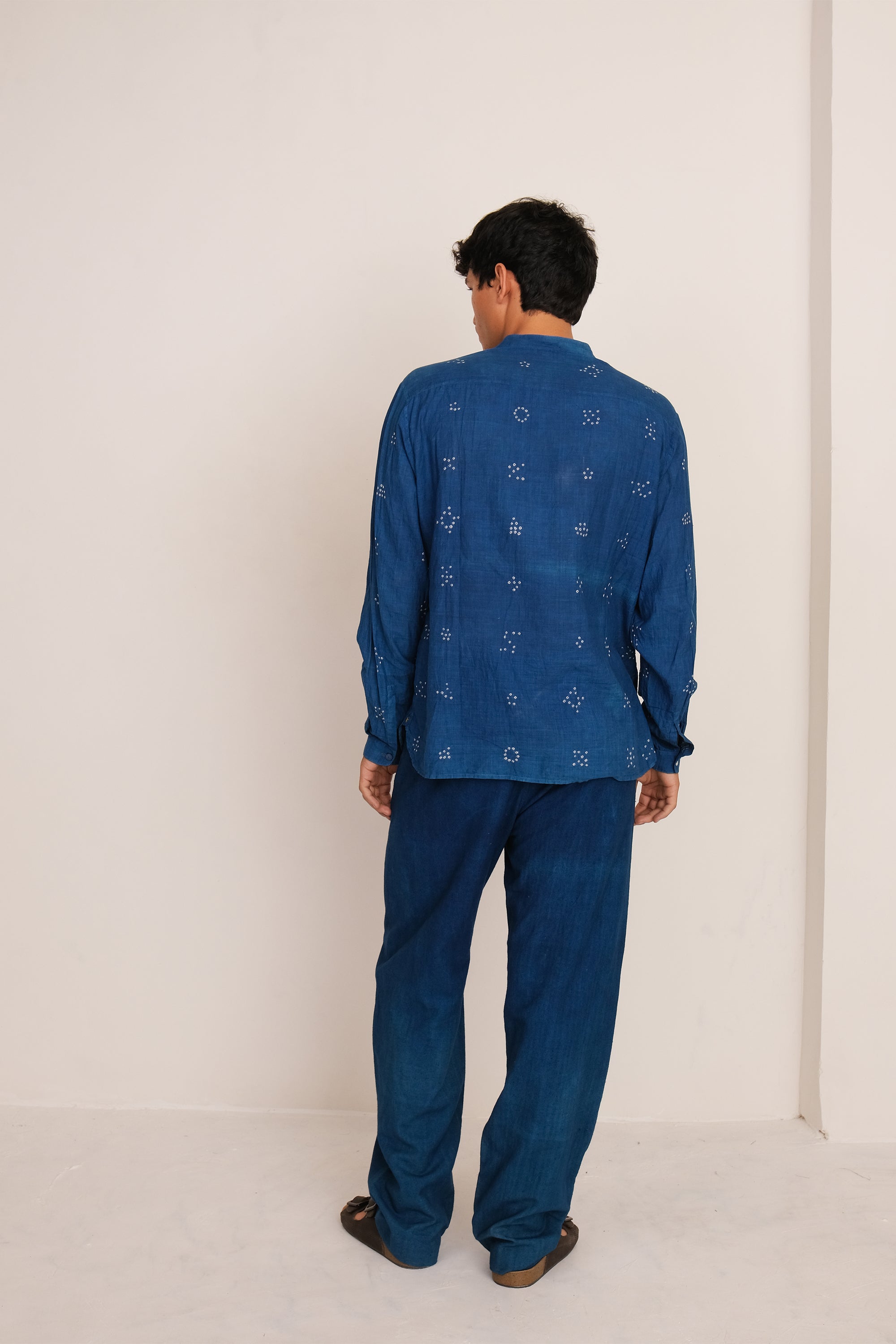 Back shot a man wearing of medium indigo cotton pant