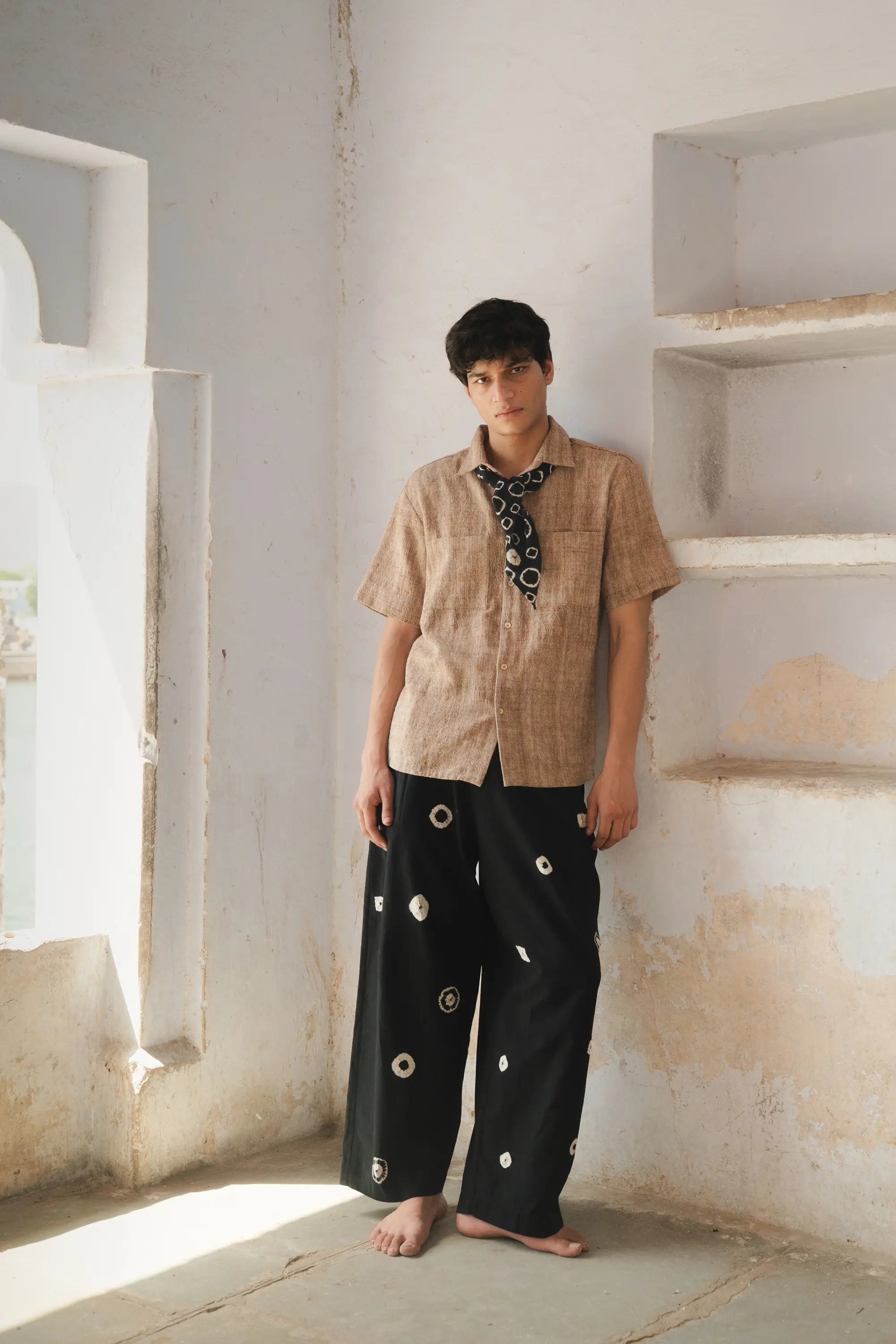 A man wearing black shibori pant