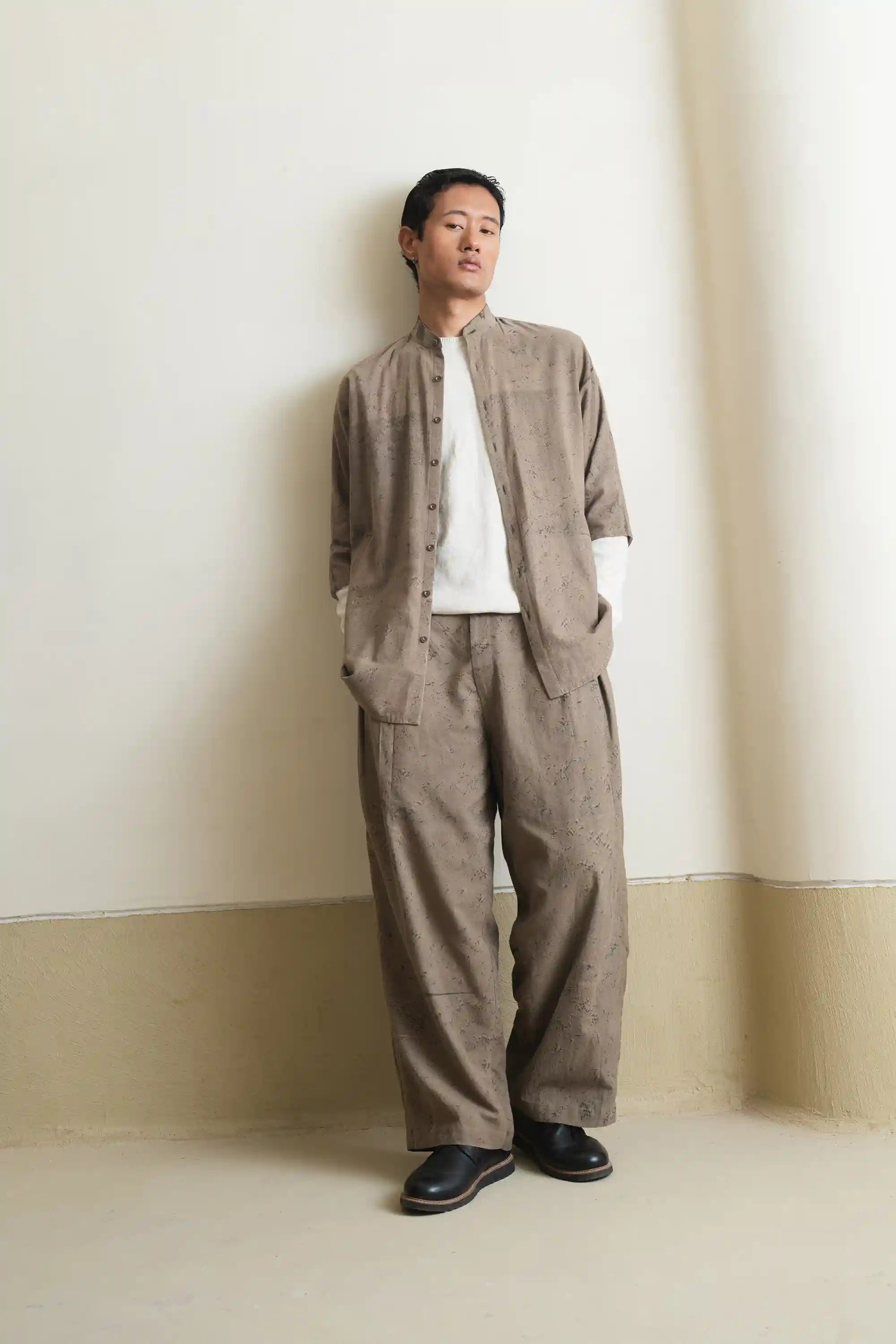 A man wearing khaki green cotton shirt with white shirt