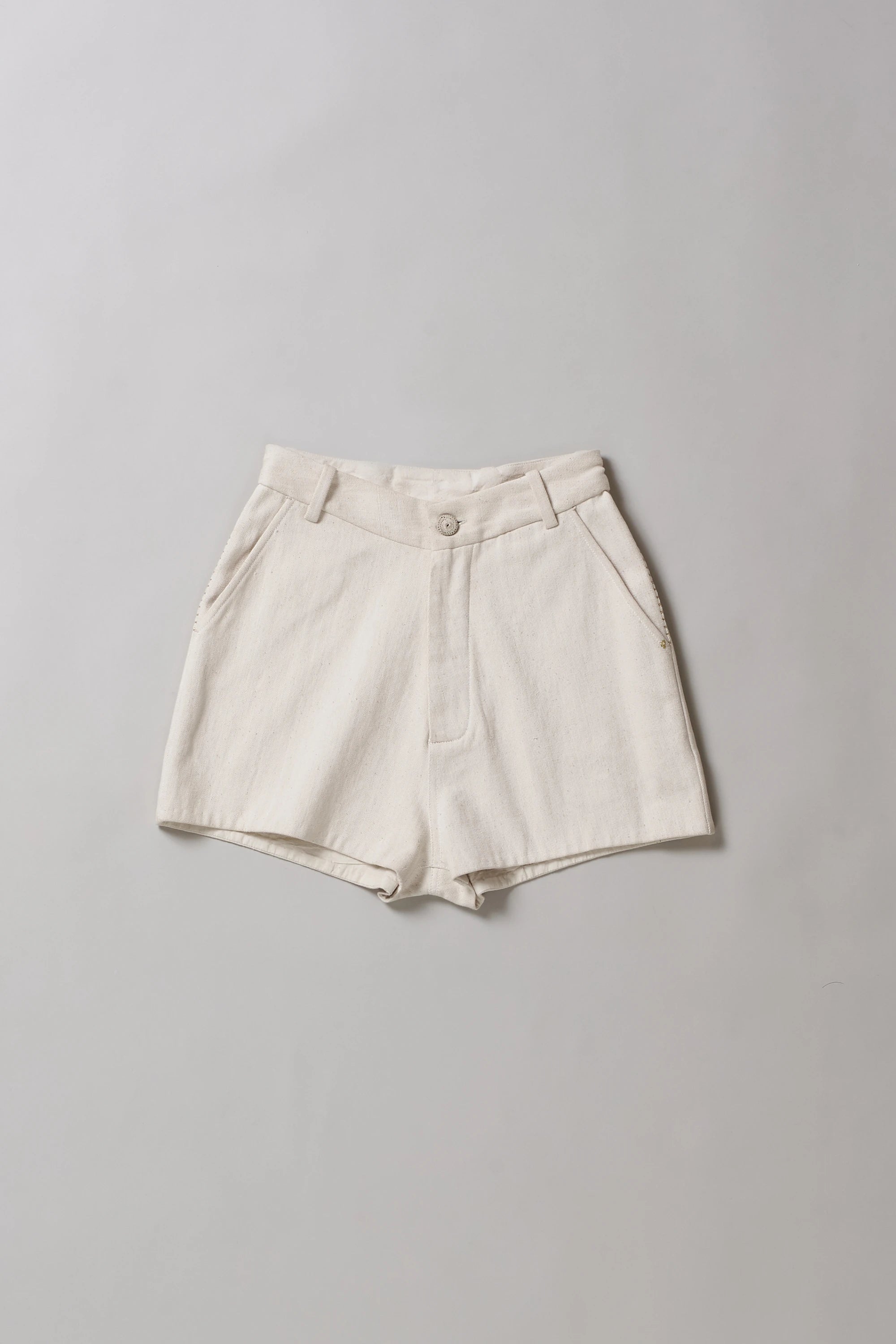 Front image of ecru shorts on a grey background