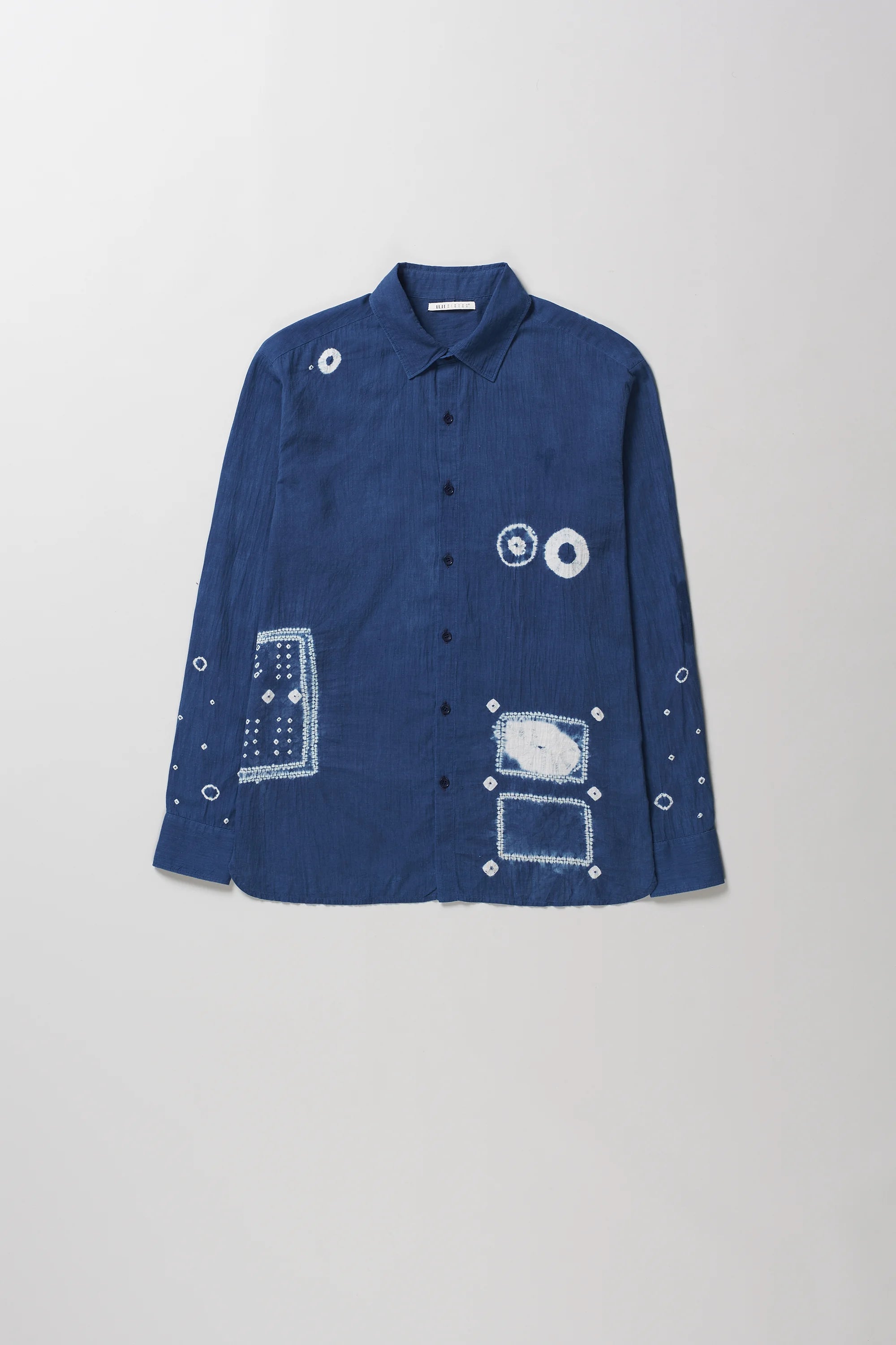 Front image of medium indigo cotton shirt with shibori details