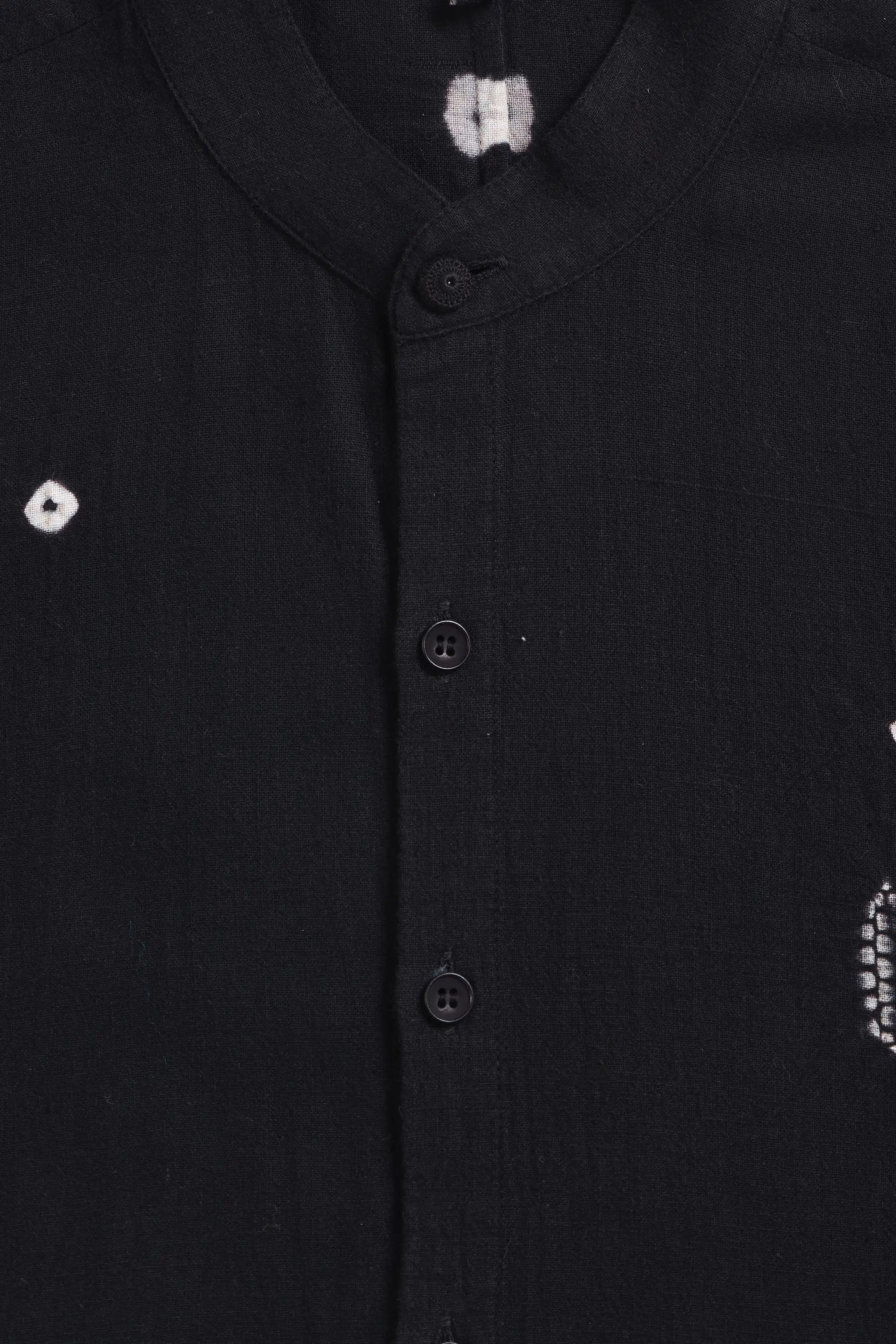 Close-up of a black shirt with shibori buttons
