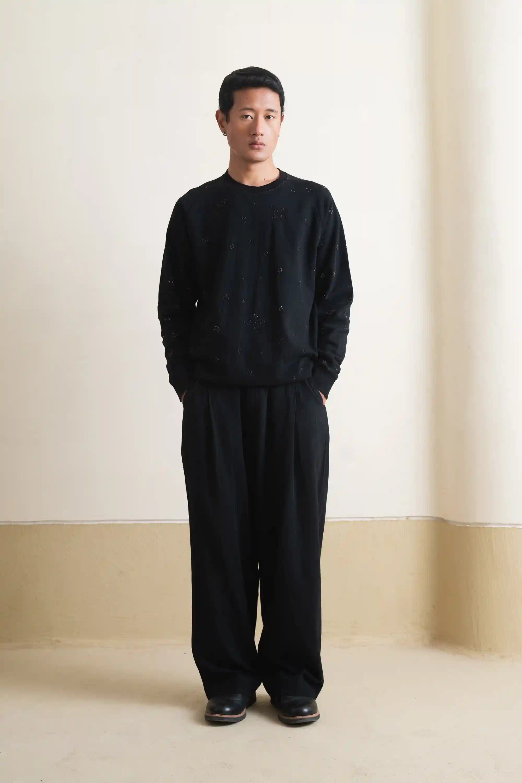 A man wearing black bandhani sweatshirt