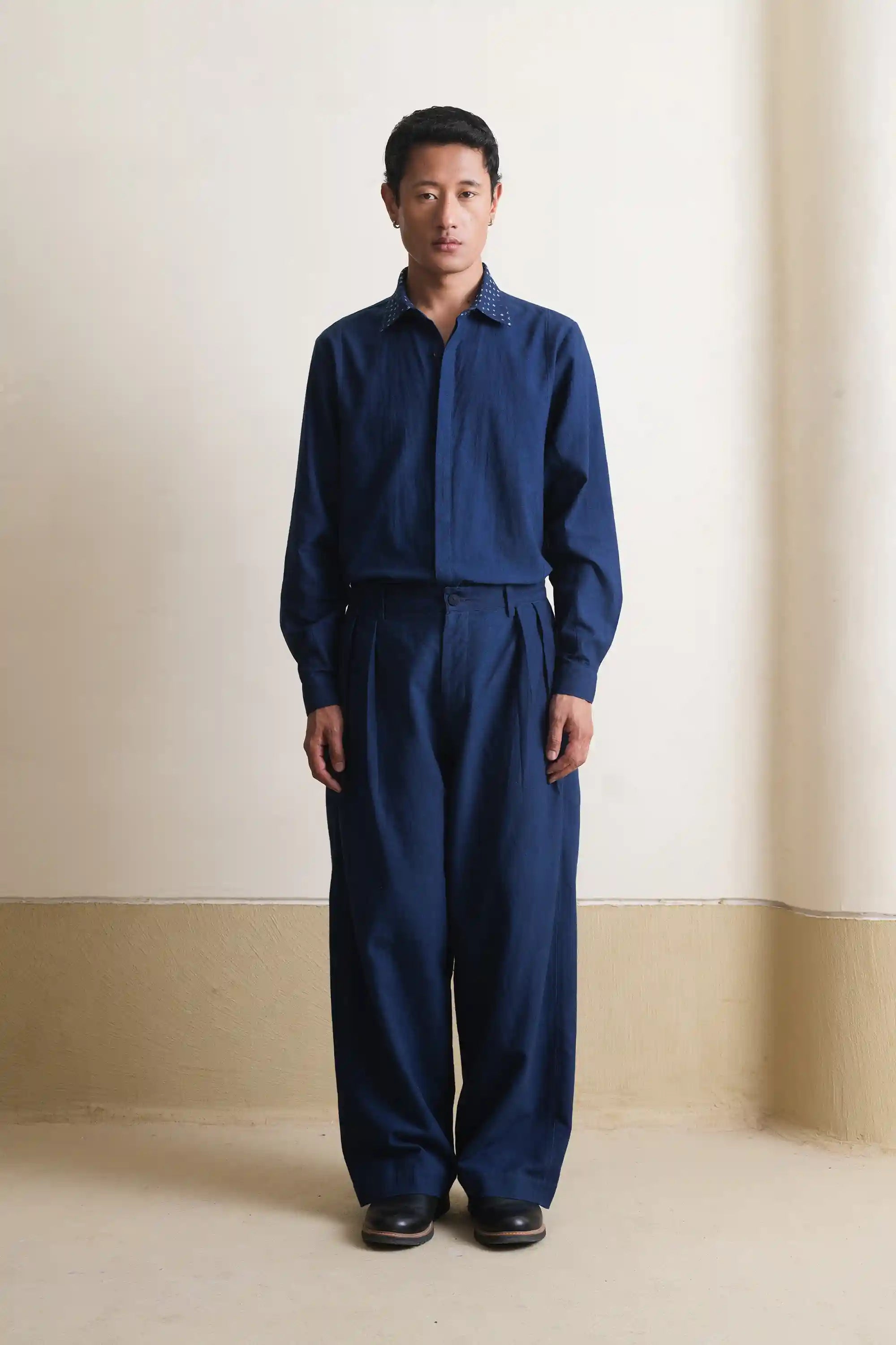 A man wearing cotton indigo shirt with black pant