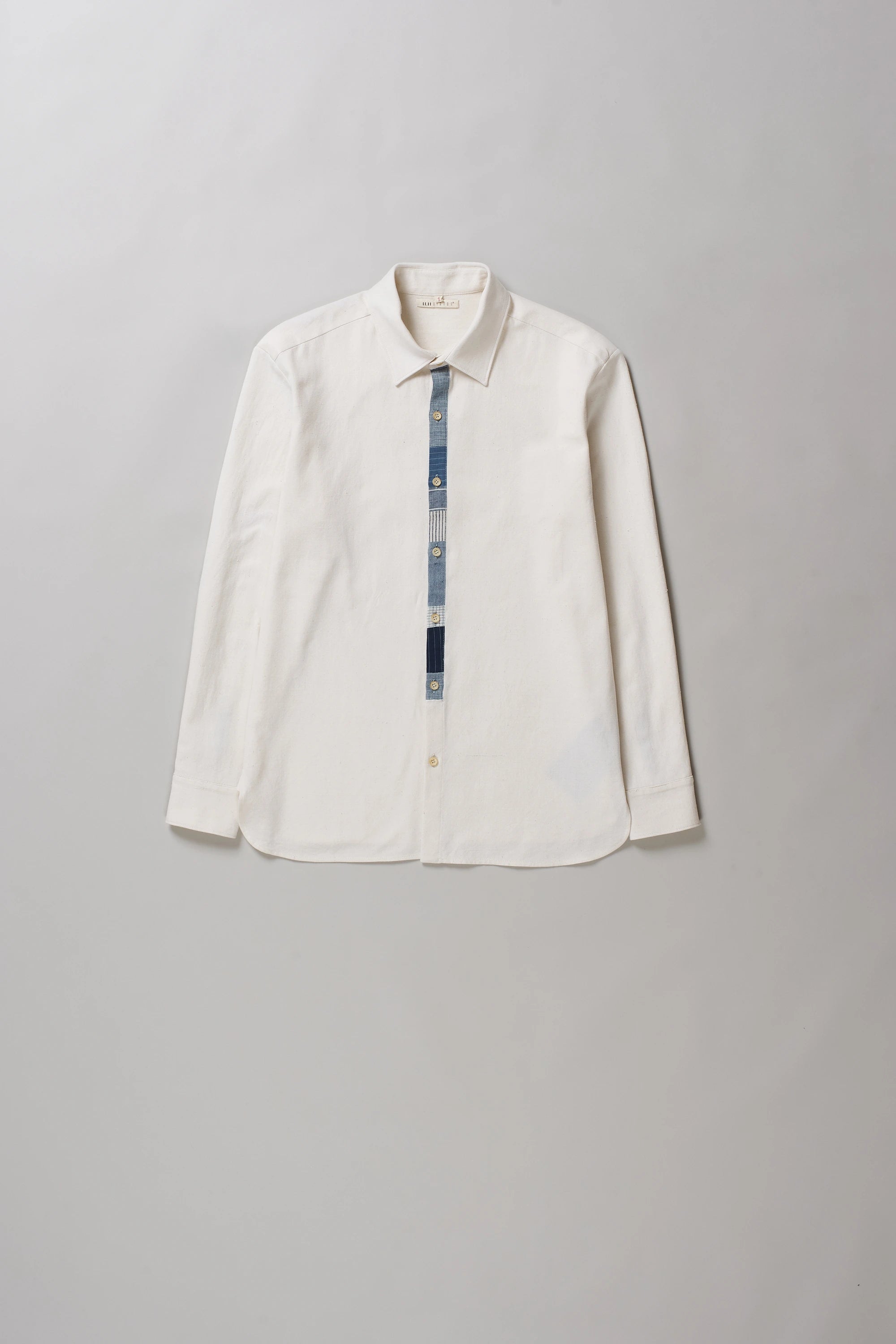 An off-white long-sleeve button-up shirt in ecru