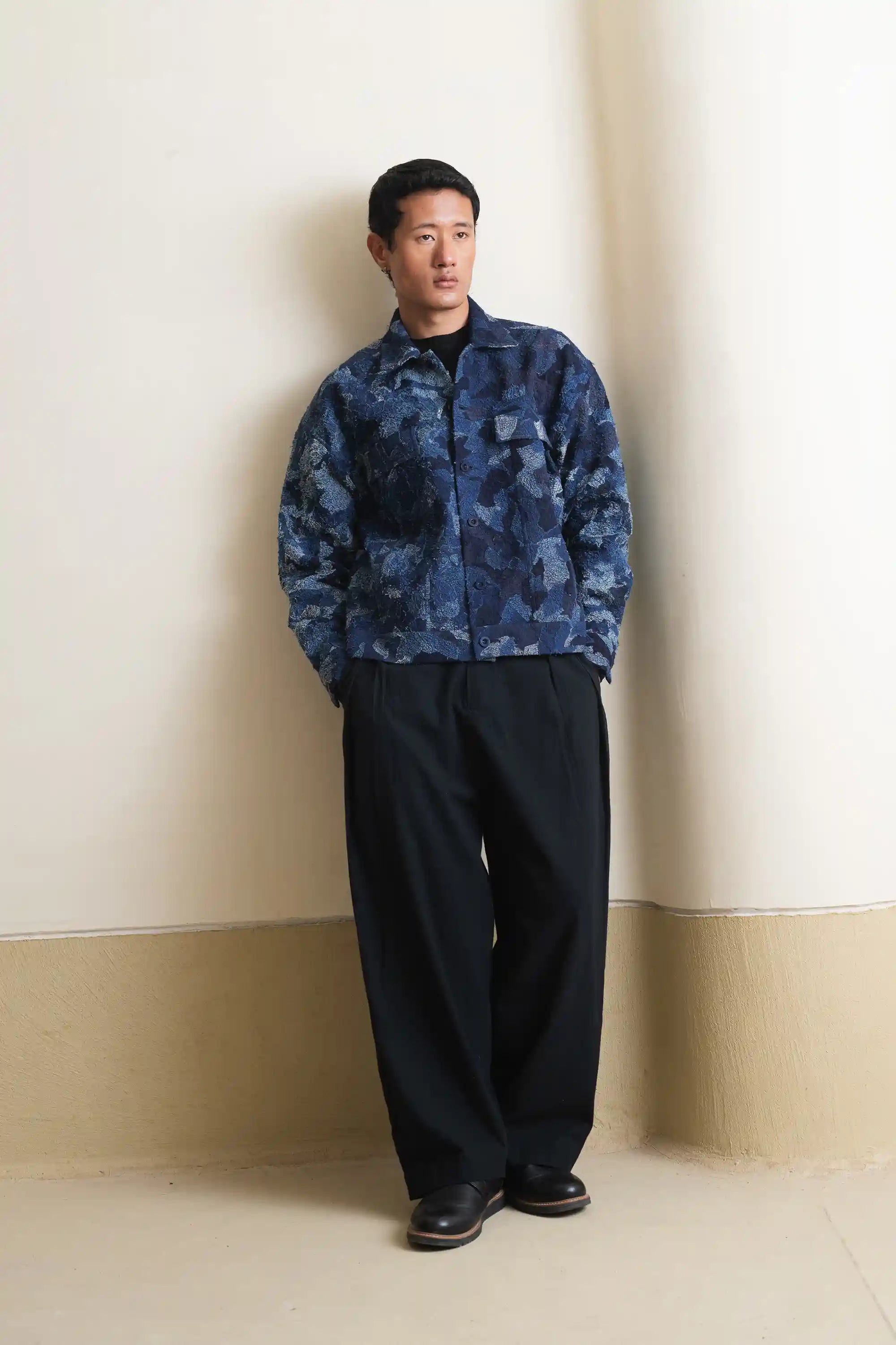 A man wearing indigo denim jacket