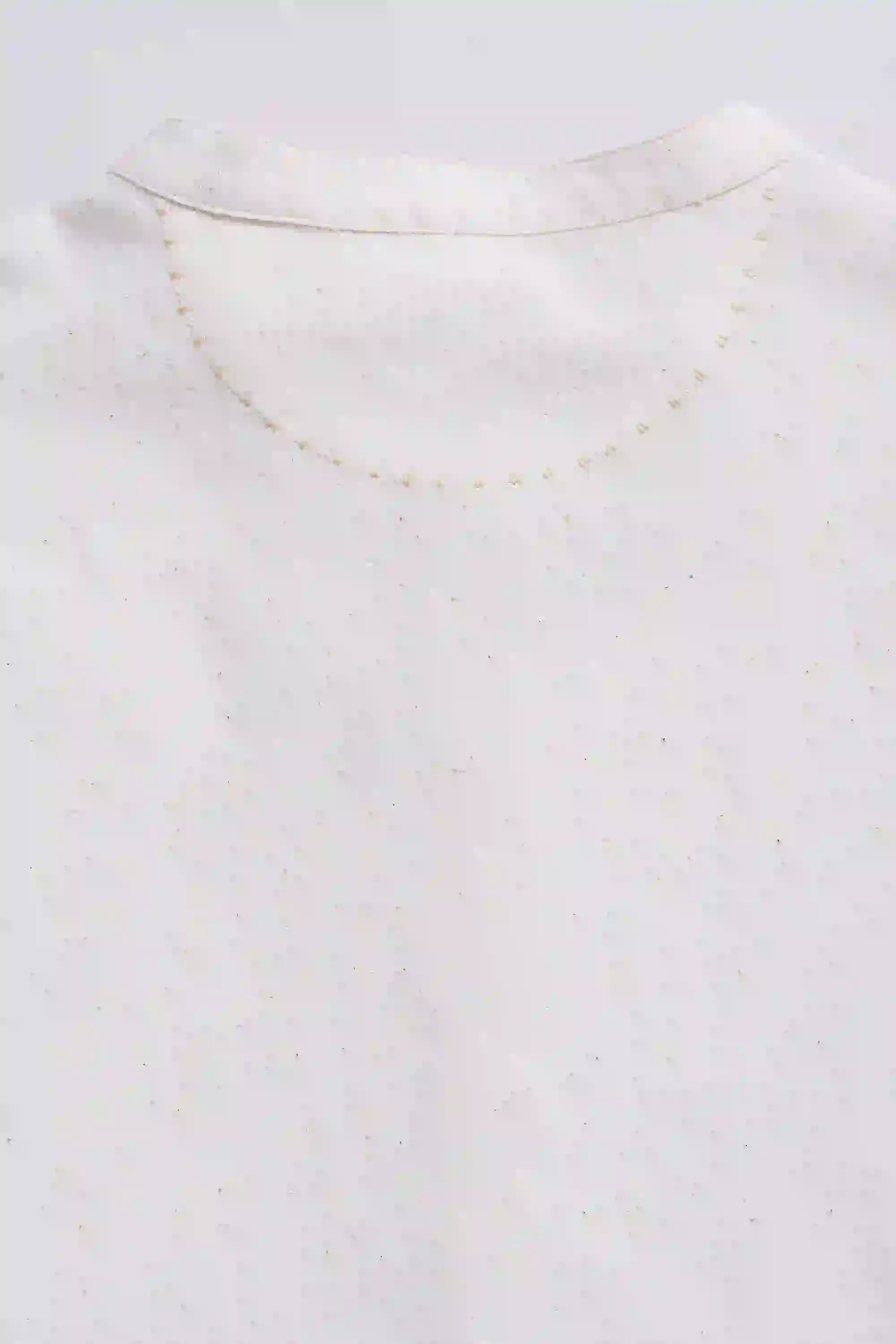 Close-up of a gold necklace on a white background