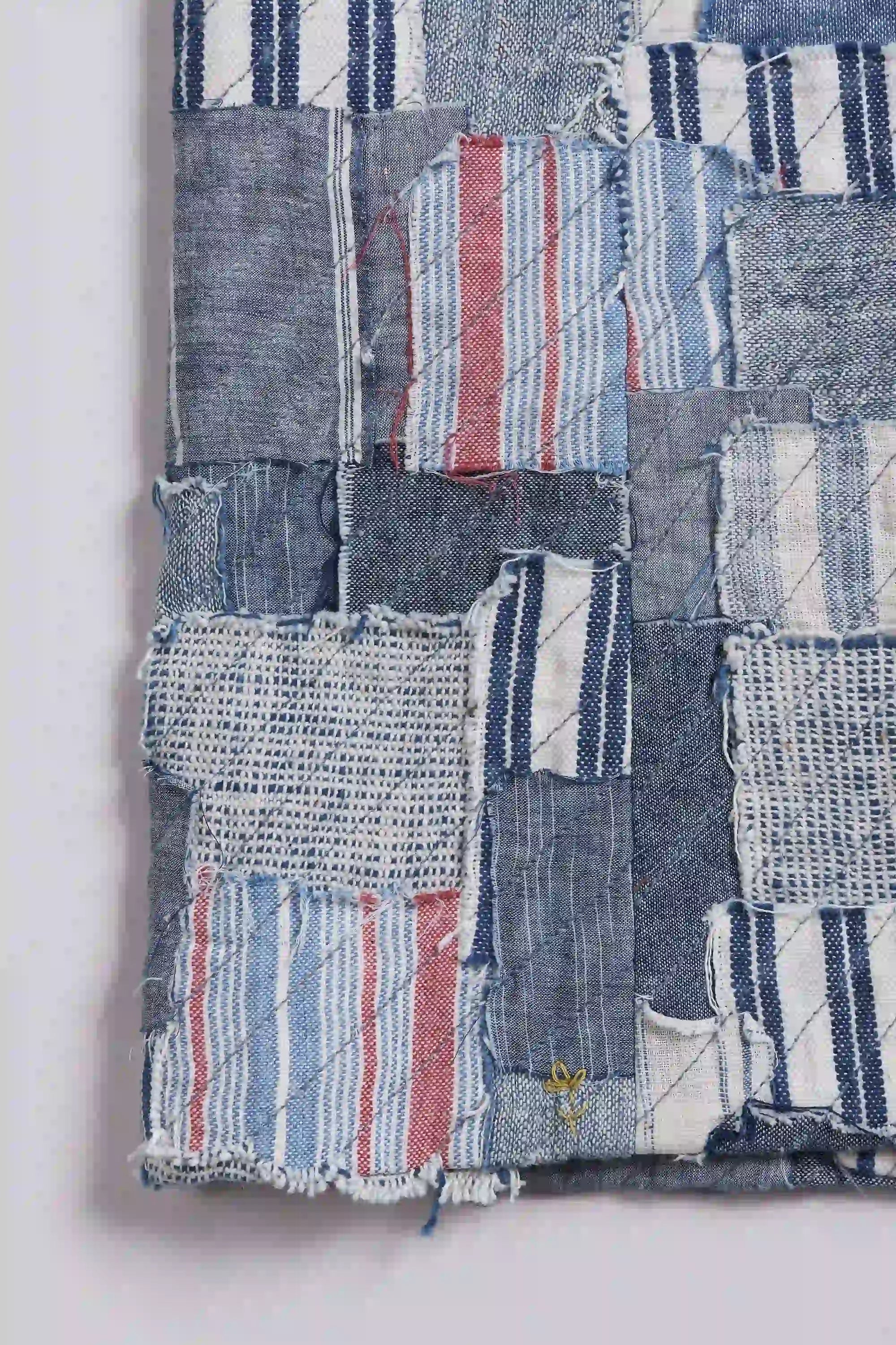 Patchwork fabric with various denim patterns on a white background