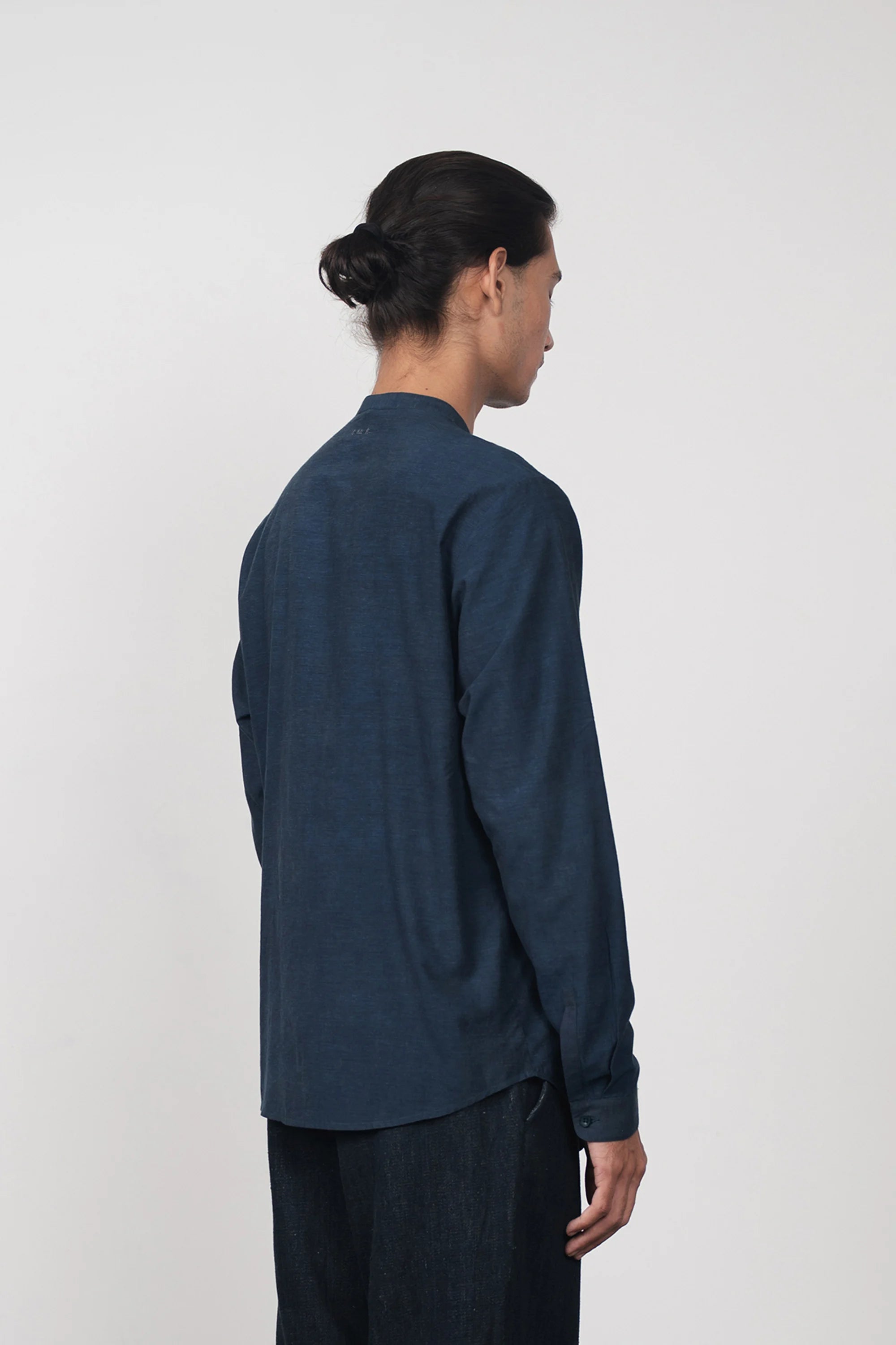 A back shot of man wearing estate blue shirt